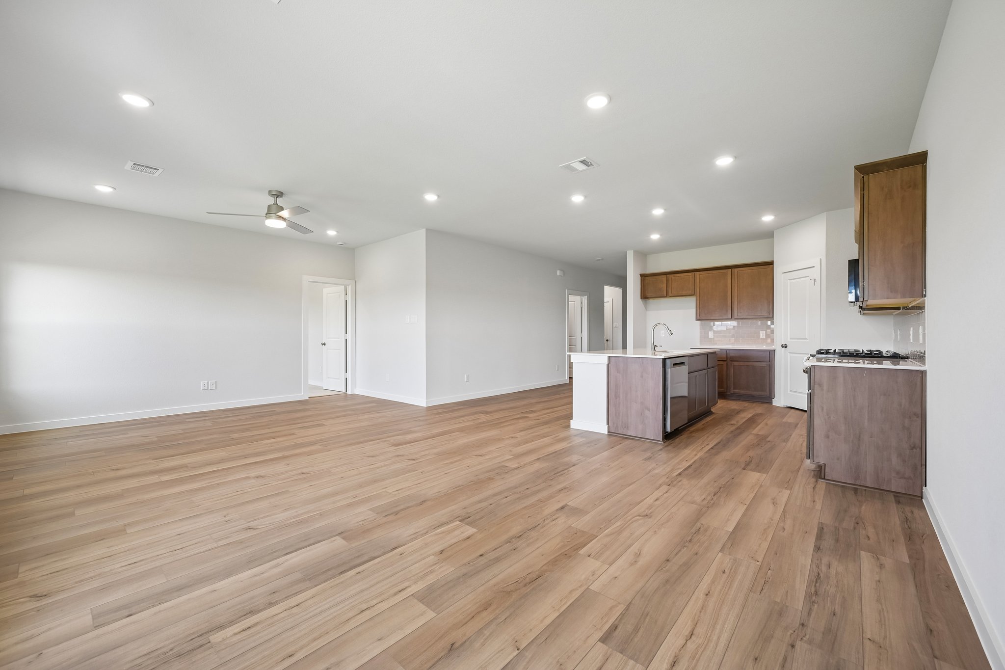A large kitchen with wooden floors.