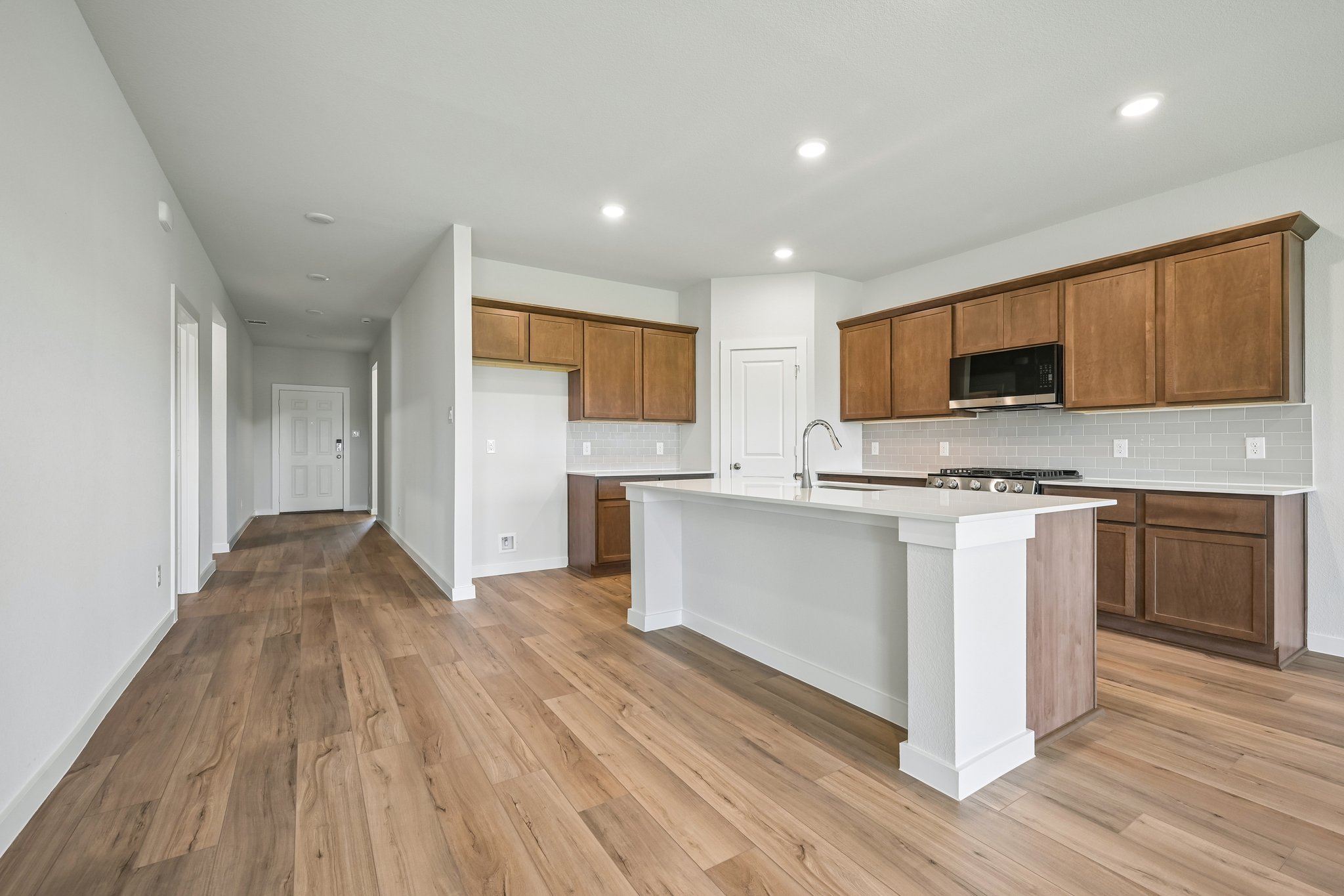 A kitchen with wooden cabinets.
