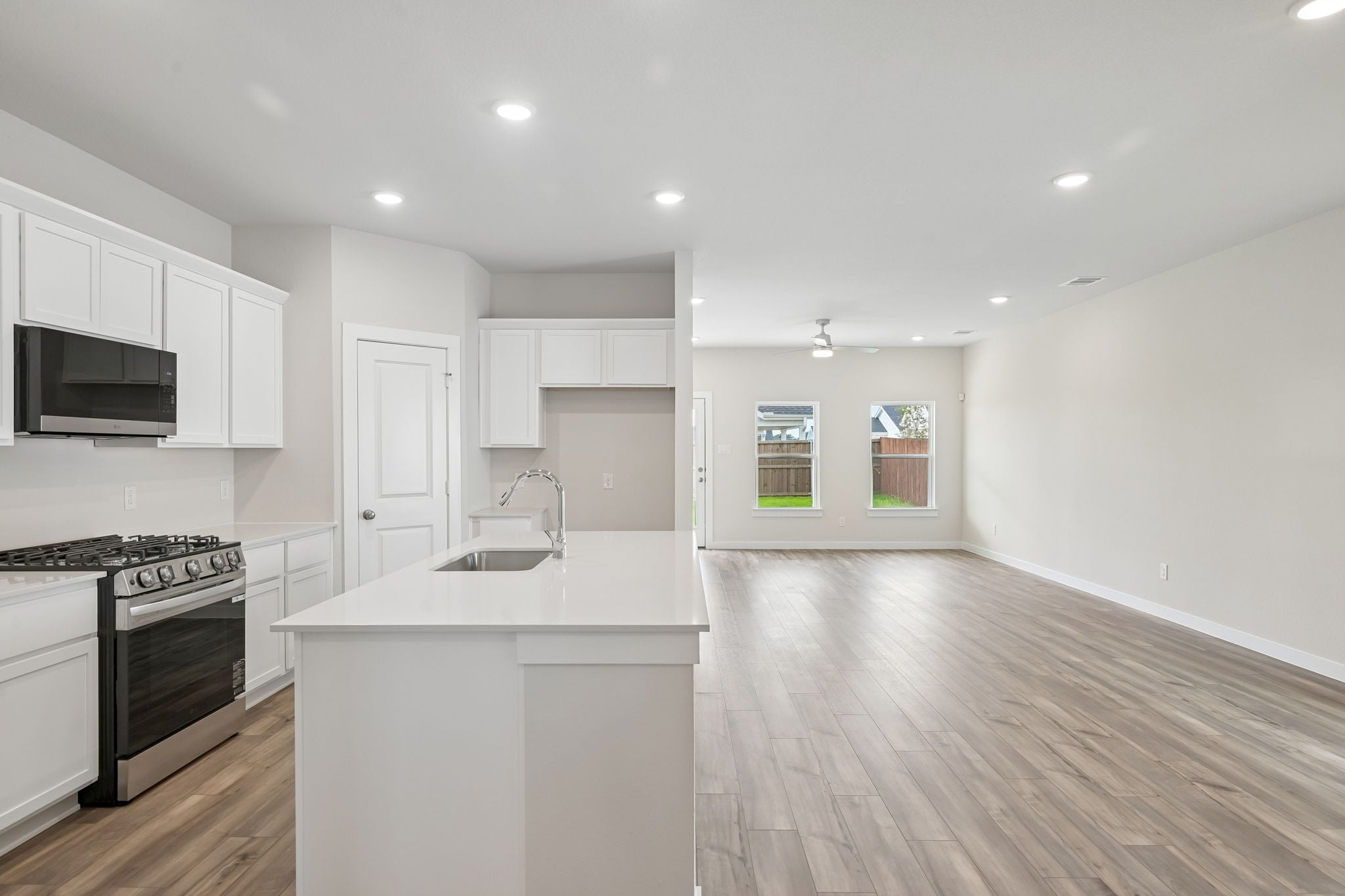 A kitchen with white cabinets.