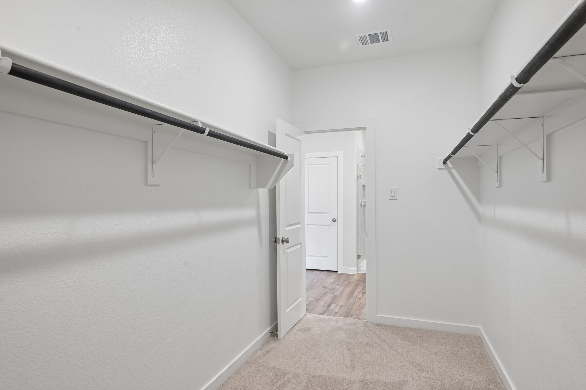 A hallway with white doors.