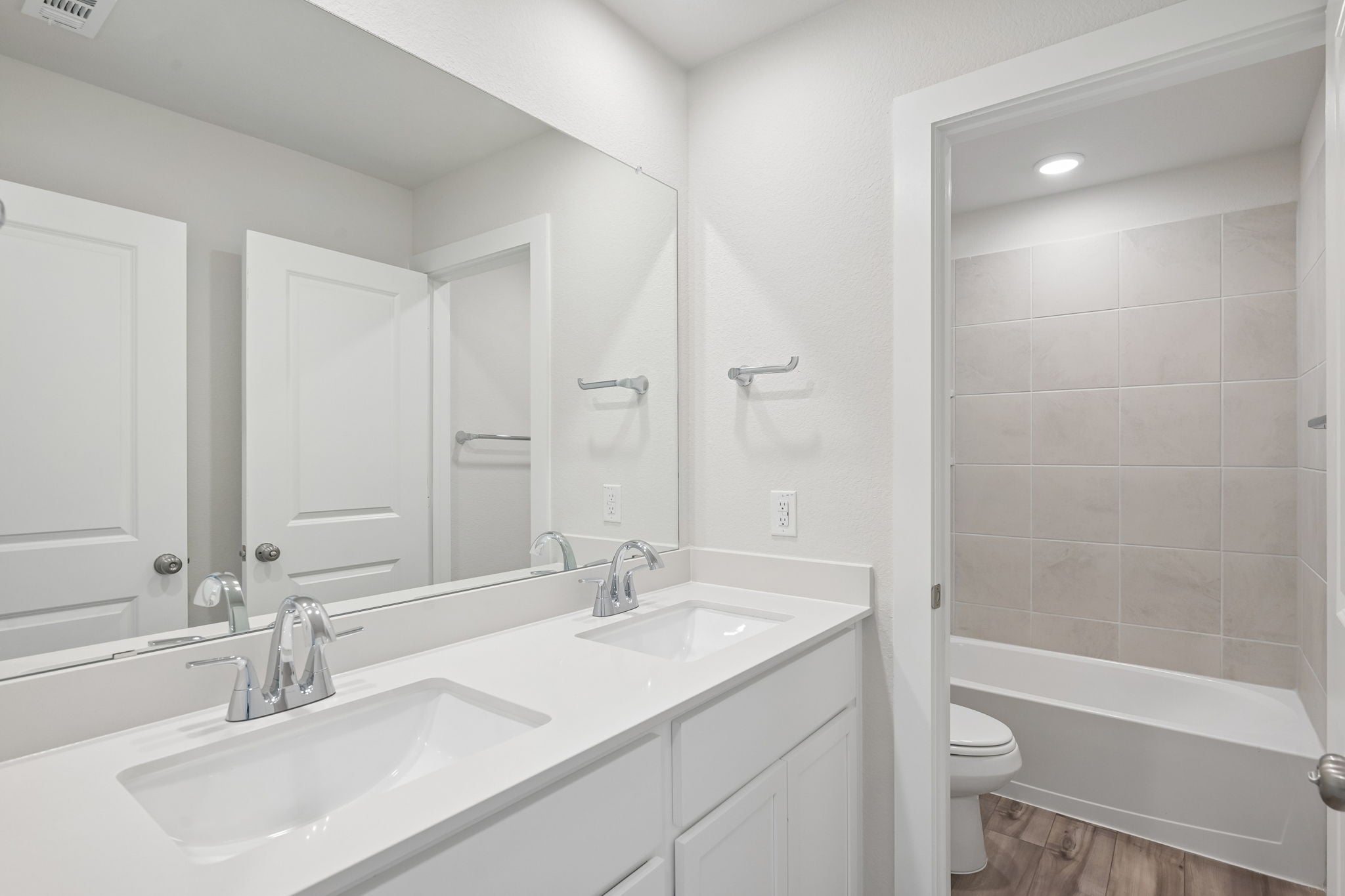 A bathroom with a tub sink and toilet.