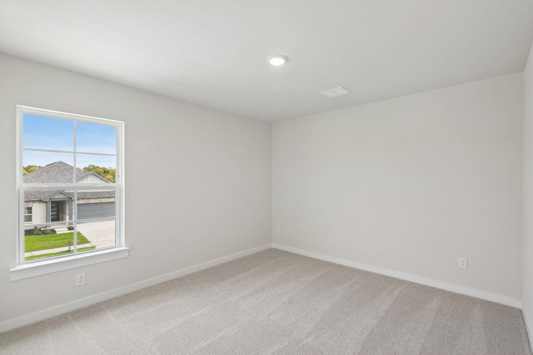 A room with a window and a plant in it.