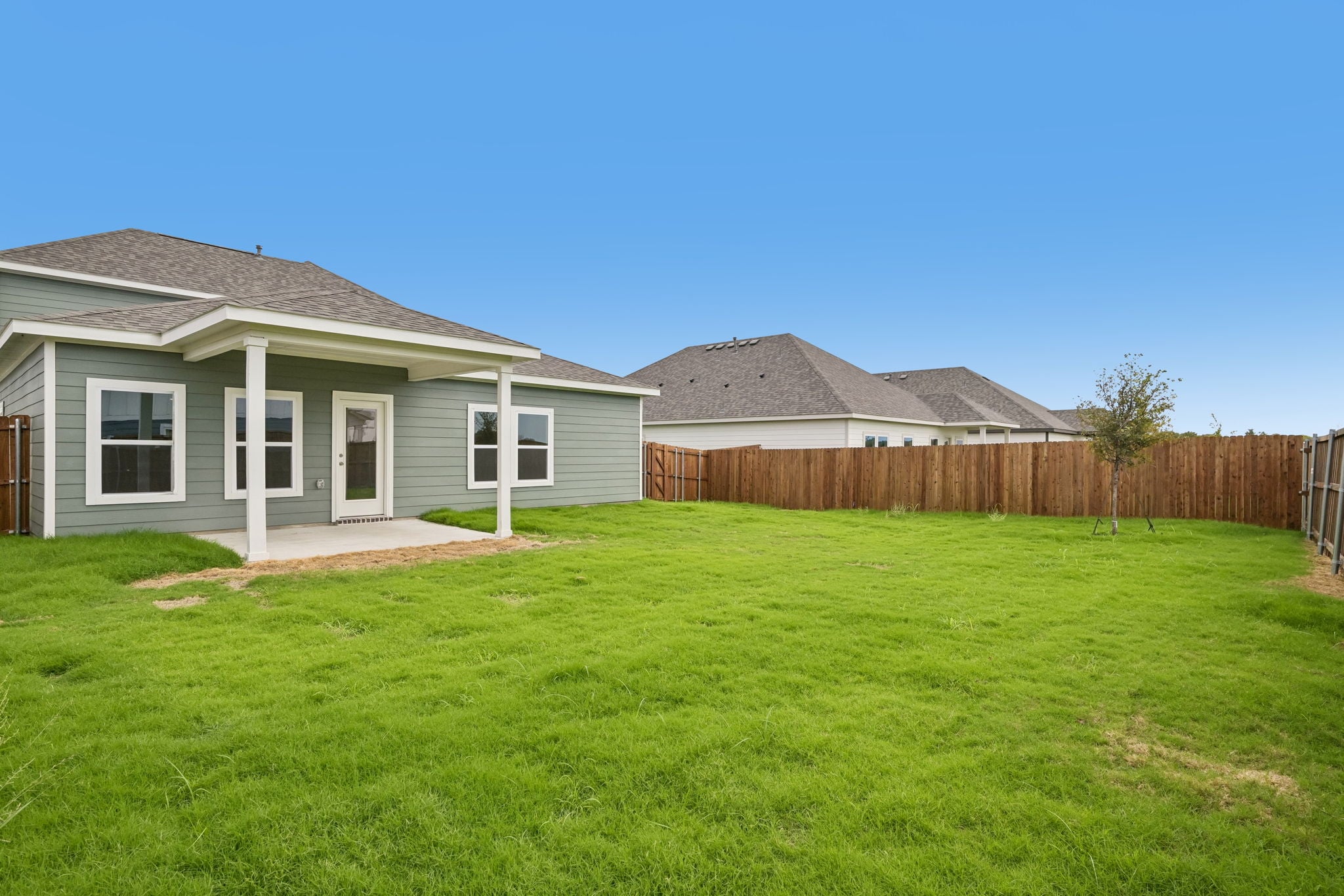A house with a fence and grass.