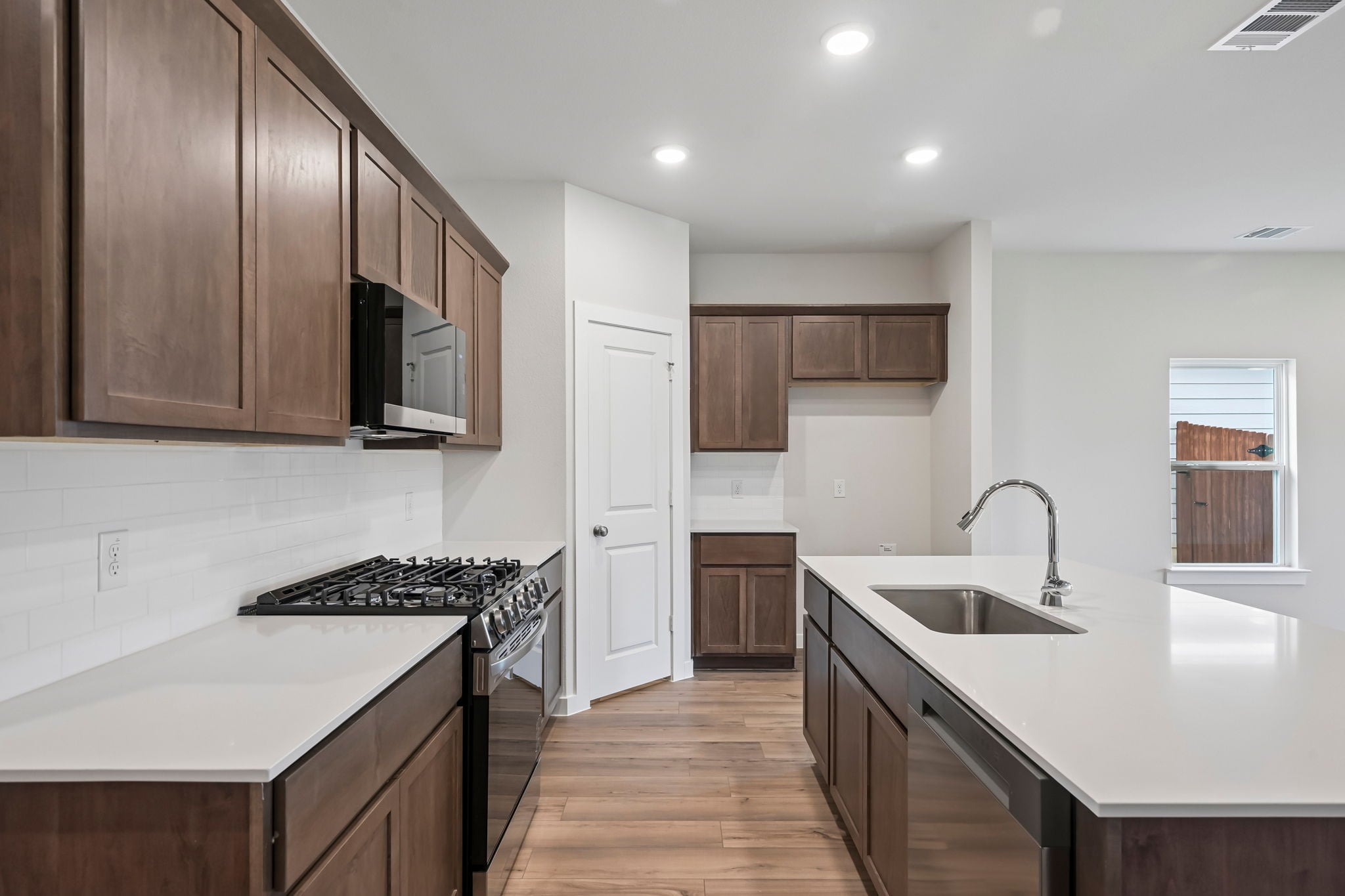 A kitchen with wooden cabinets.