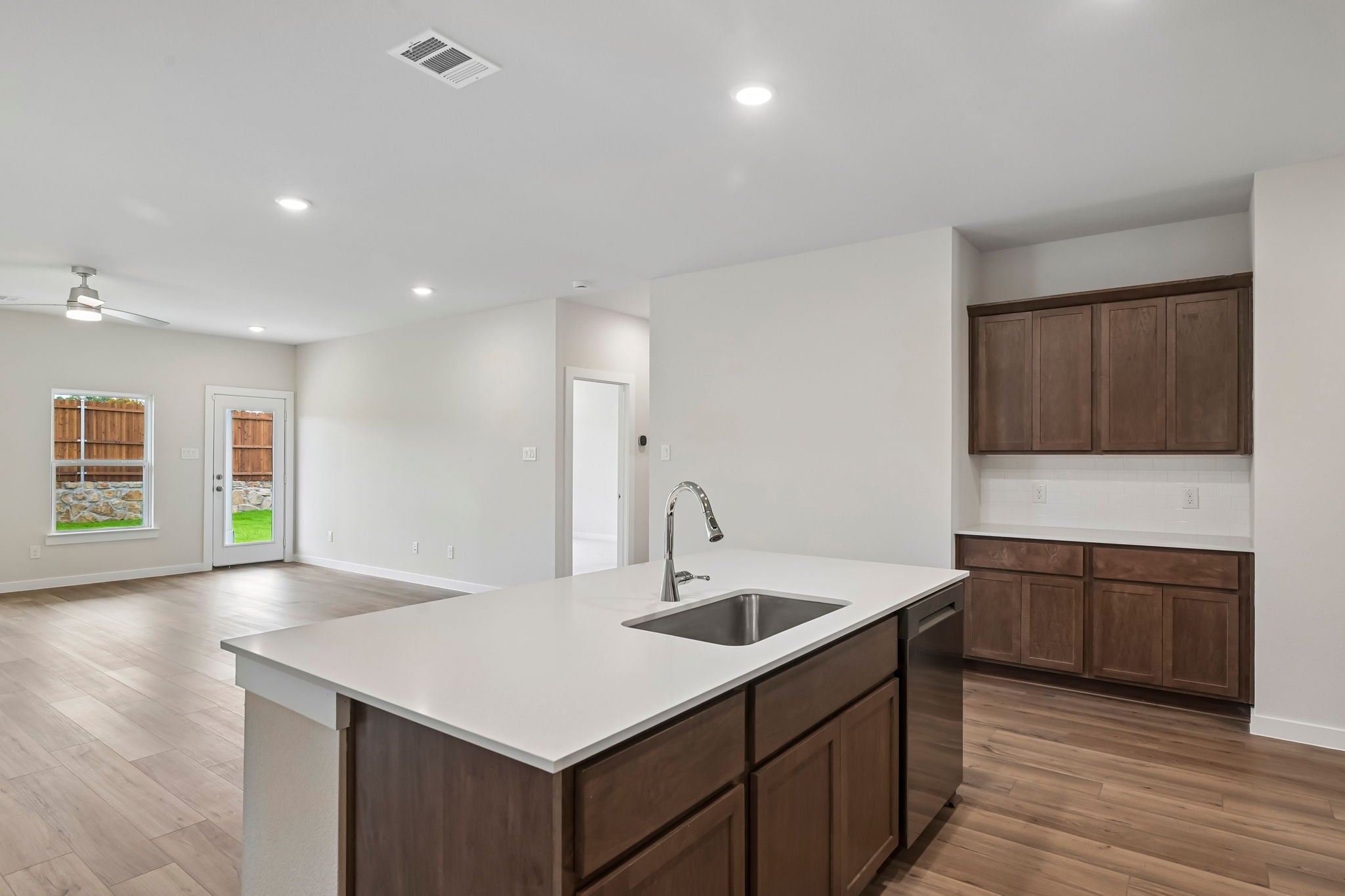 A kitchen with wooden cabinets.