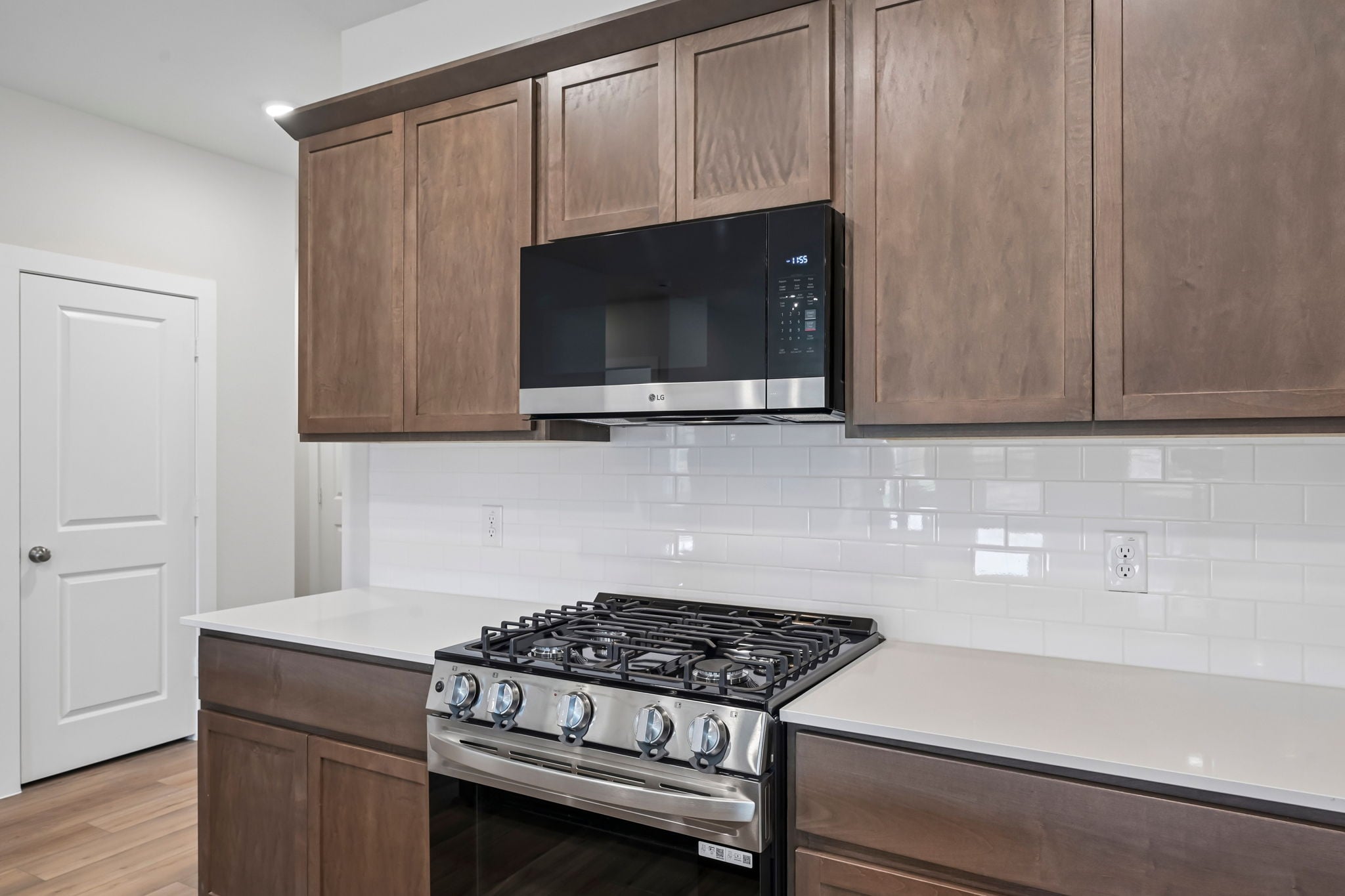 A kitchen with wooden cabinets.