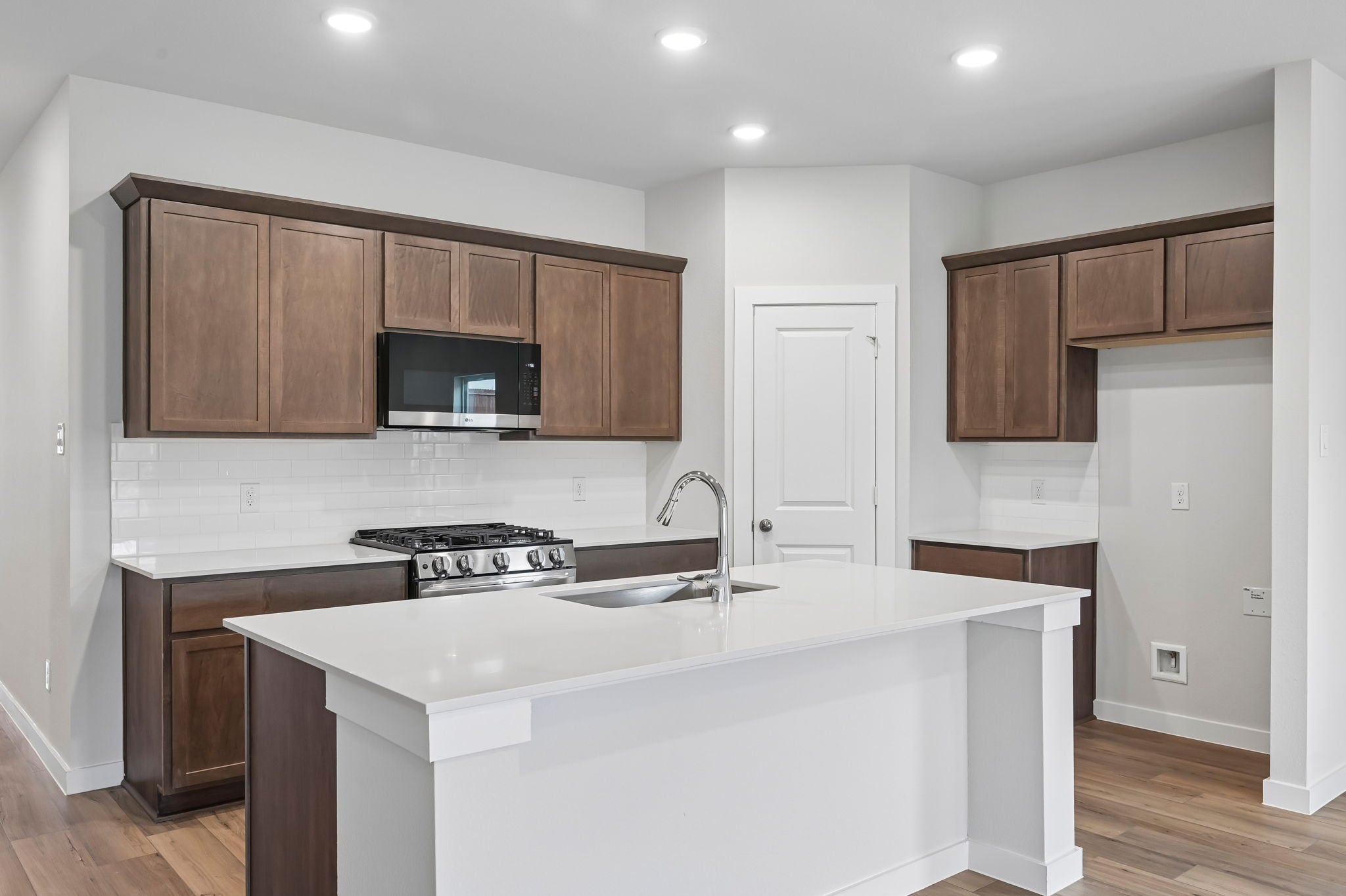 A kitchen with wooden cabinets.