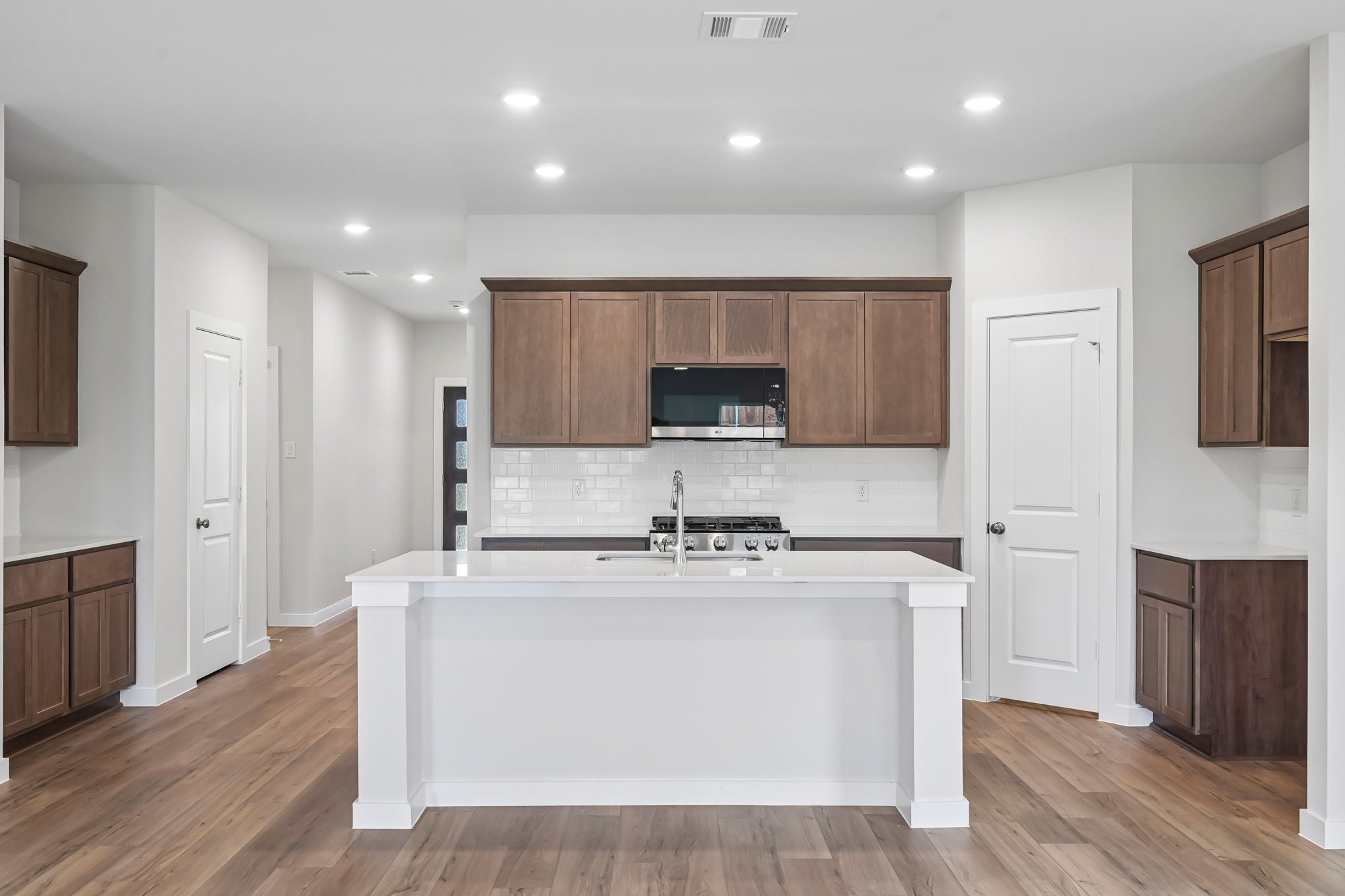 A kitchen with wooden cabinets.
