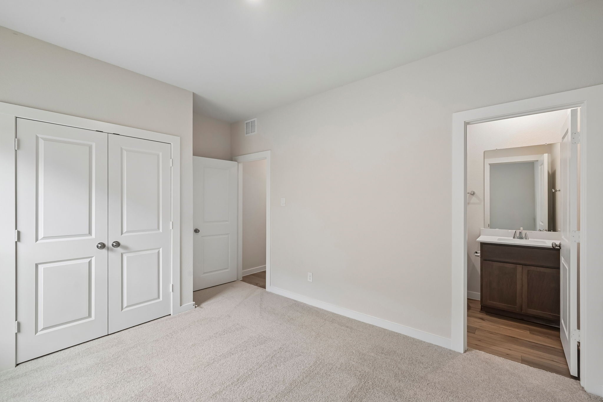 A bathroom with white doors.