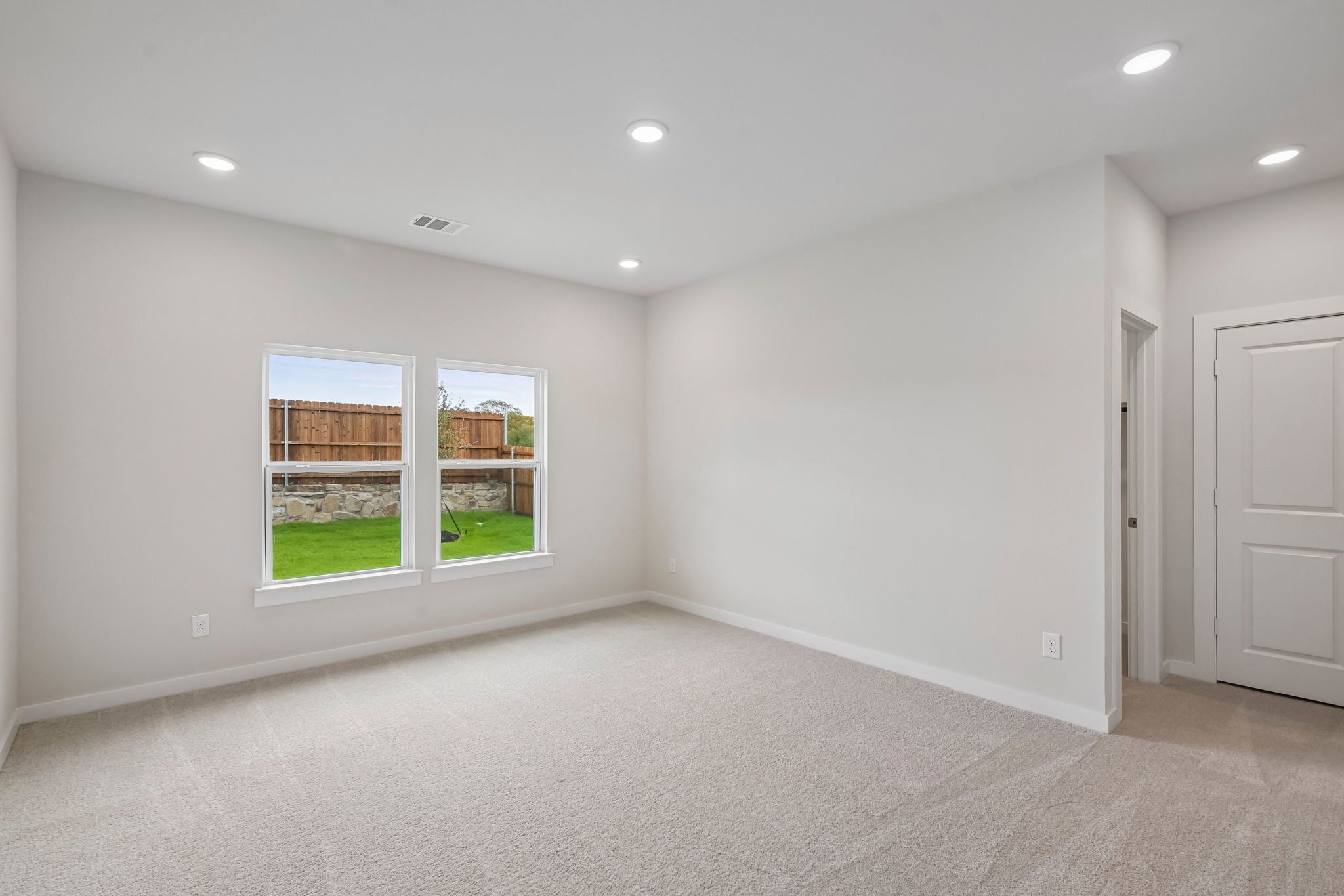 A room with a window and a door.