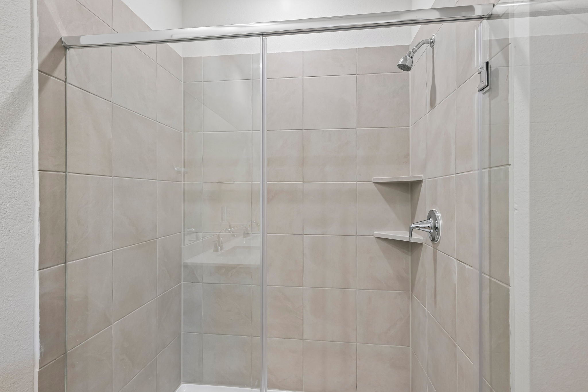 A shower with a glass door.