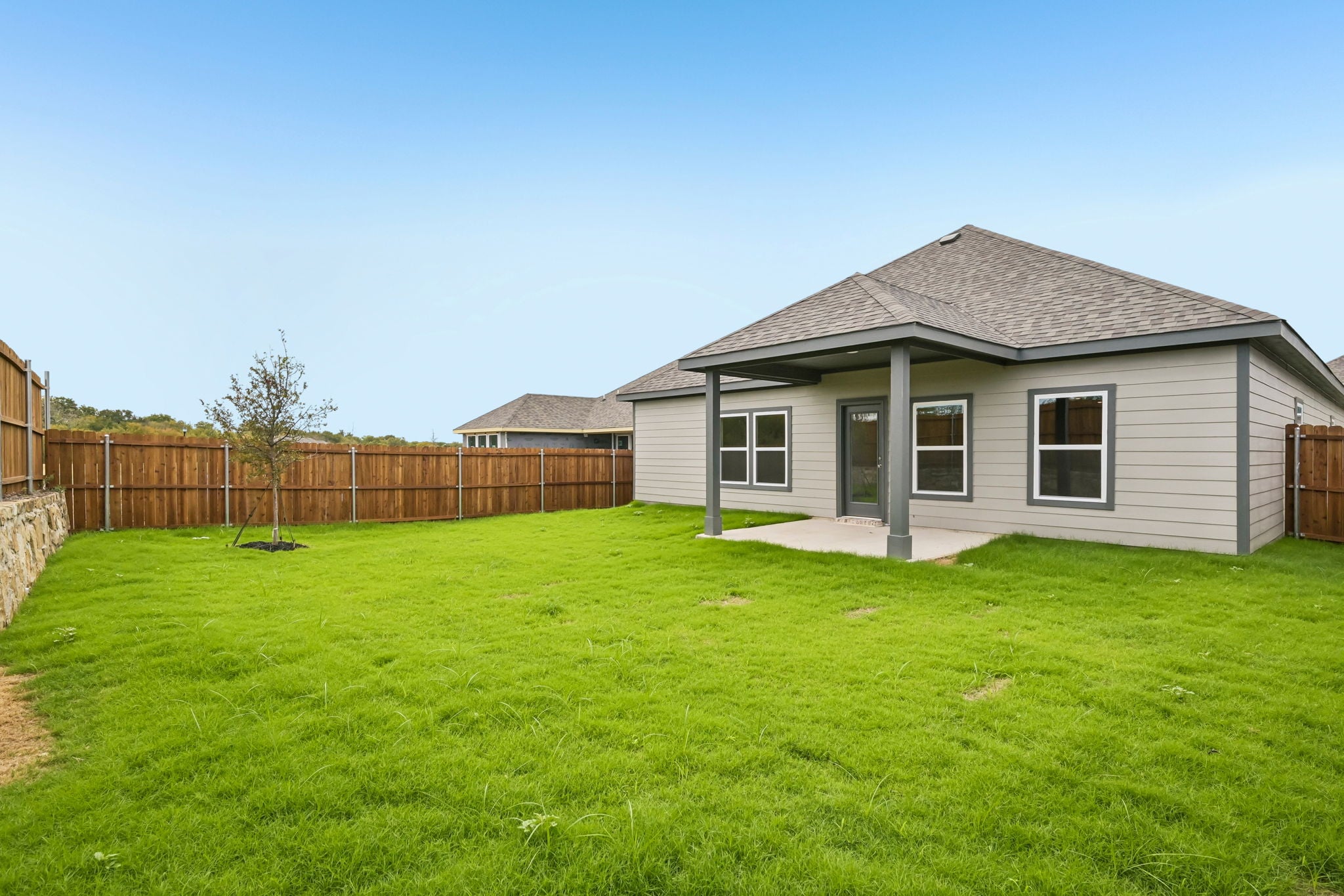A house with a fence and grass.