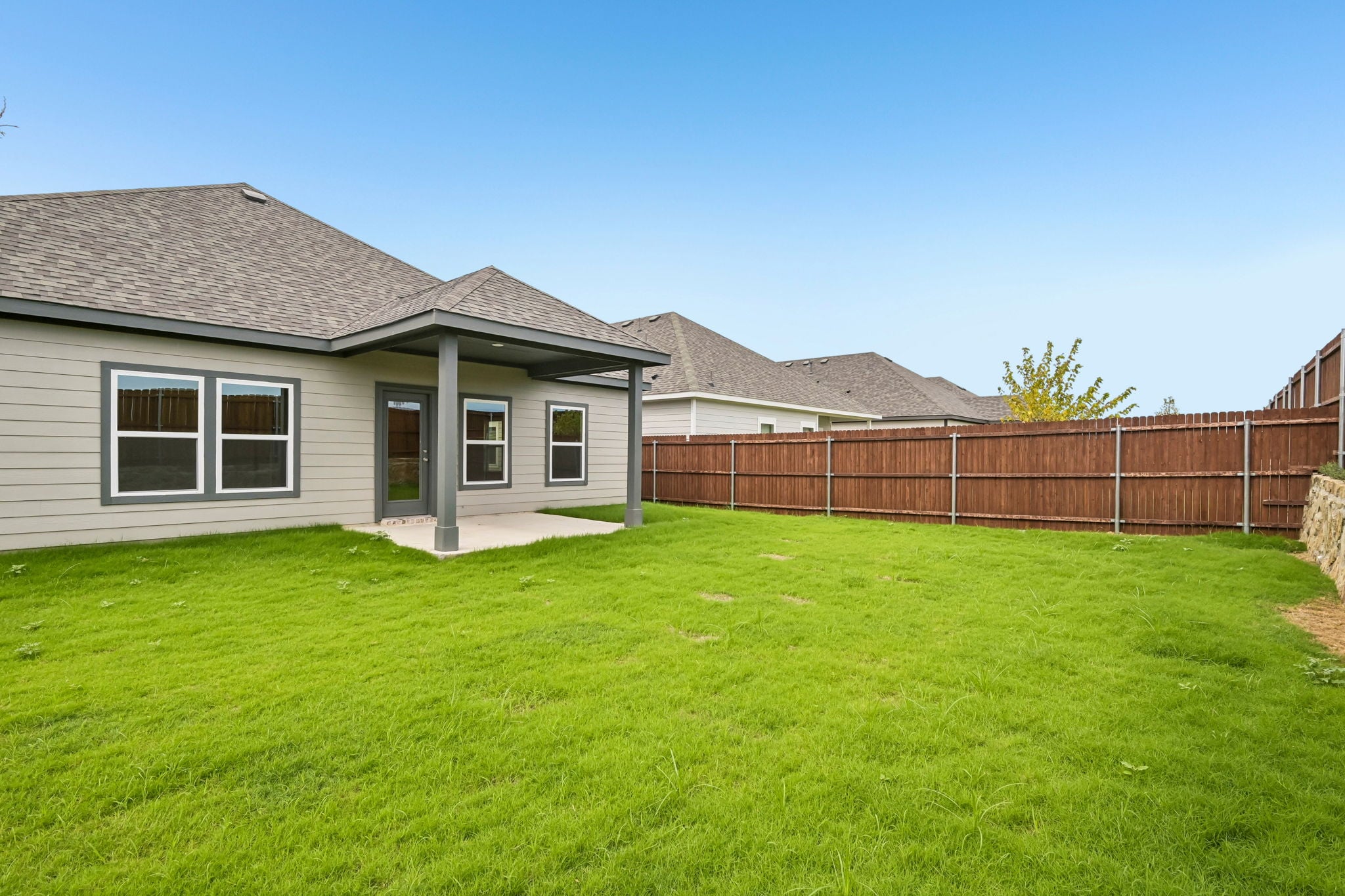 A house with a fence and grass.