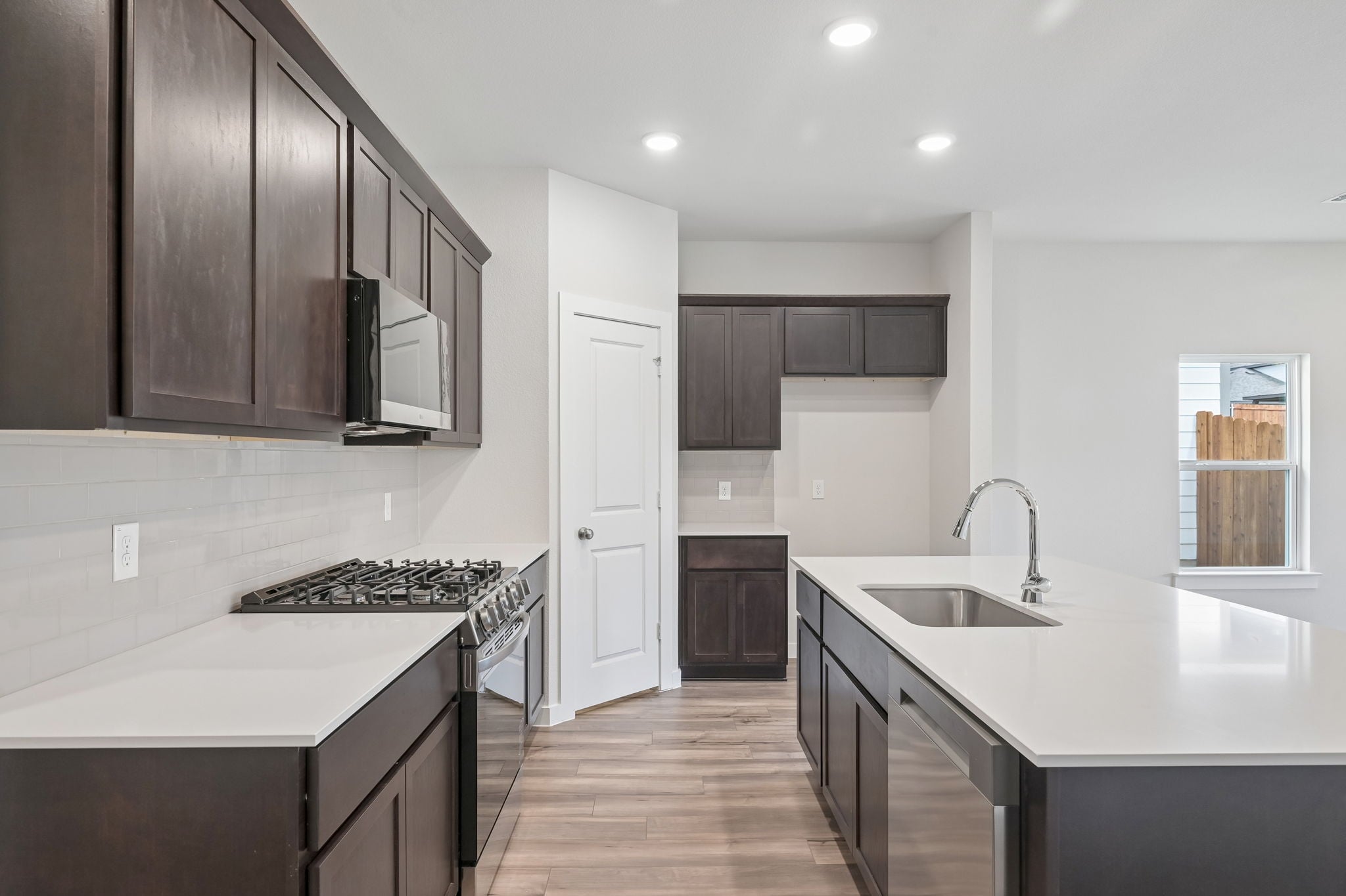 A kitchen with black cabinets.