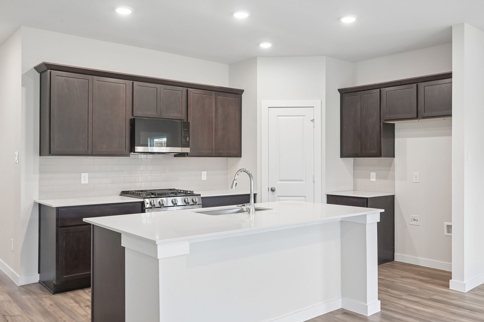 A kitchen with black cabinets.