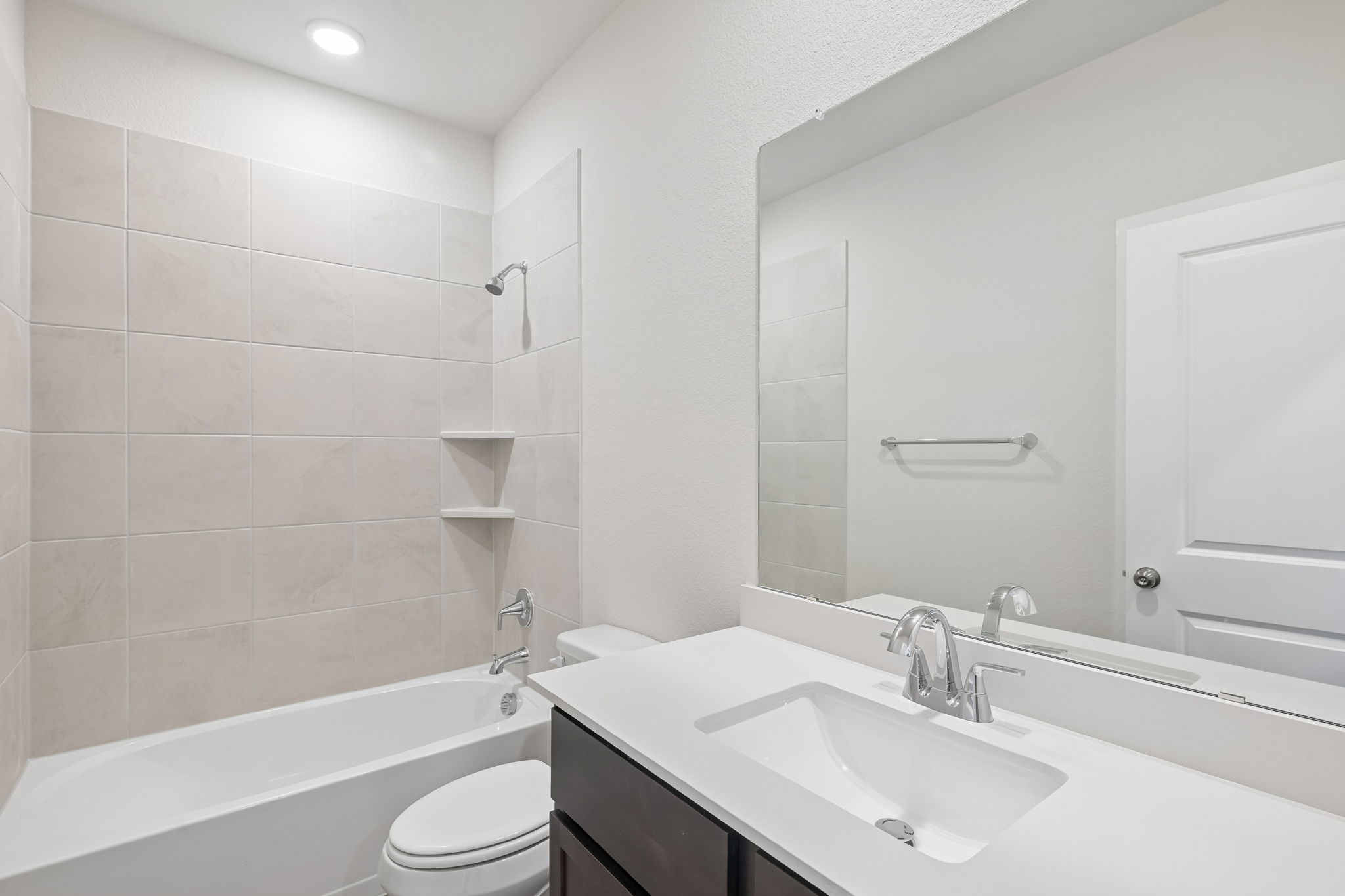 A bathroom with a tub sink and toilet.