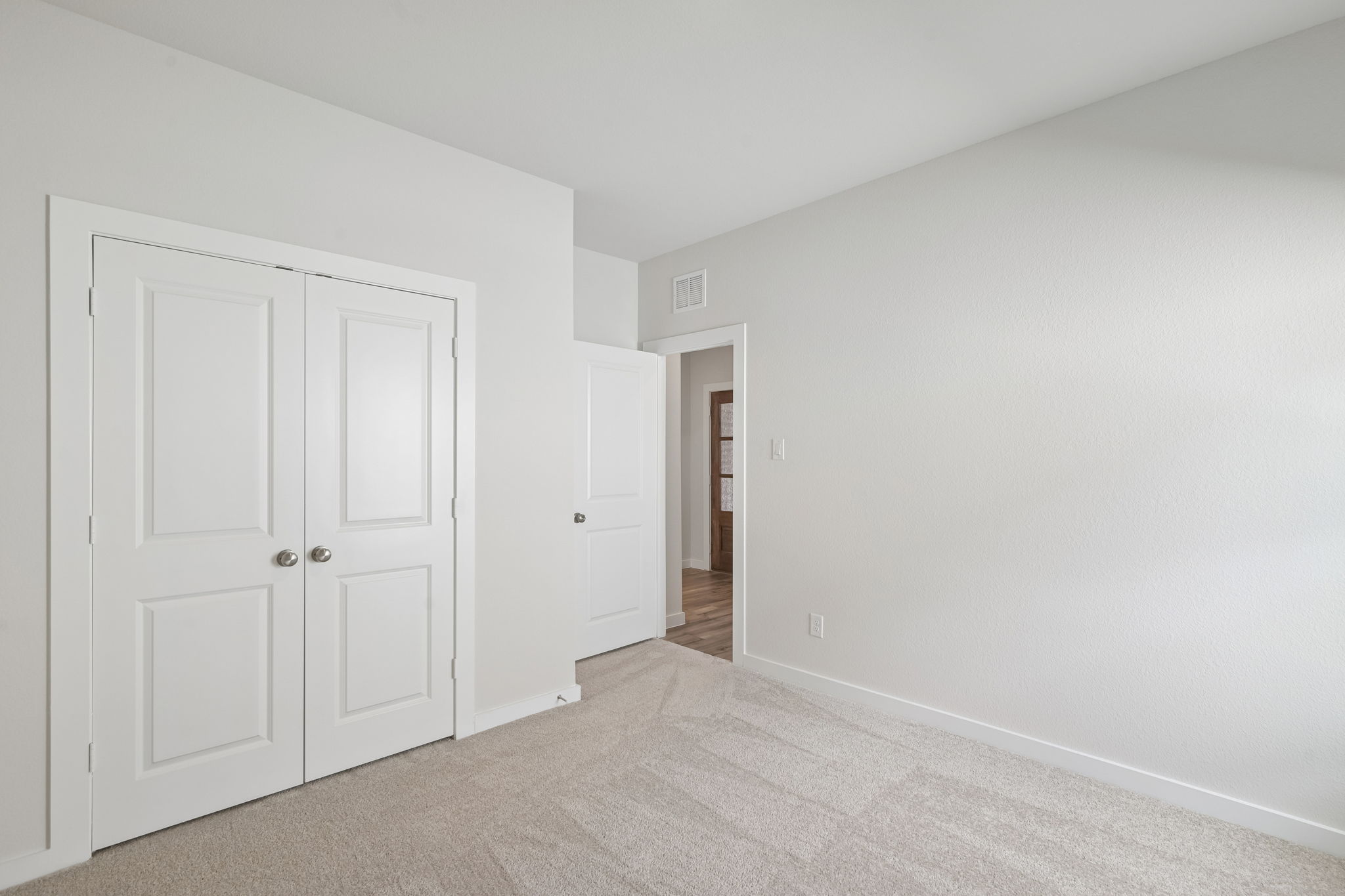 A hallway with white doors.