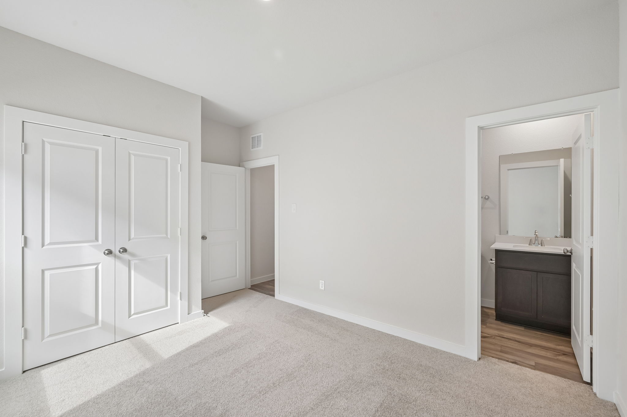 A bathroom with white doors.
