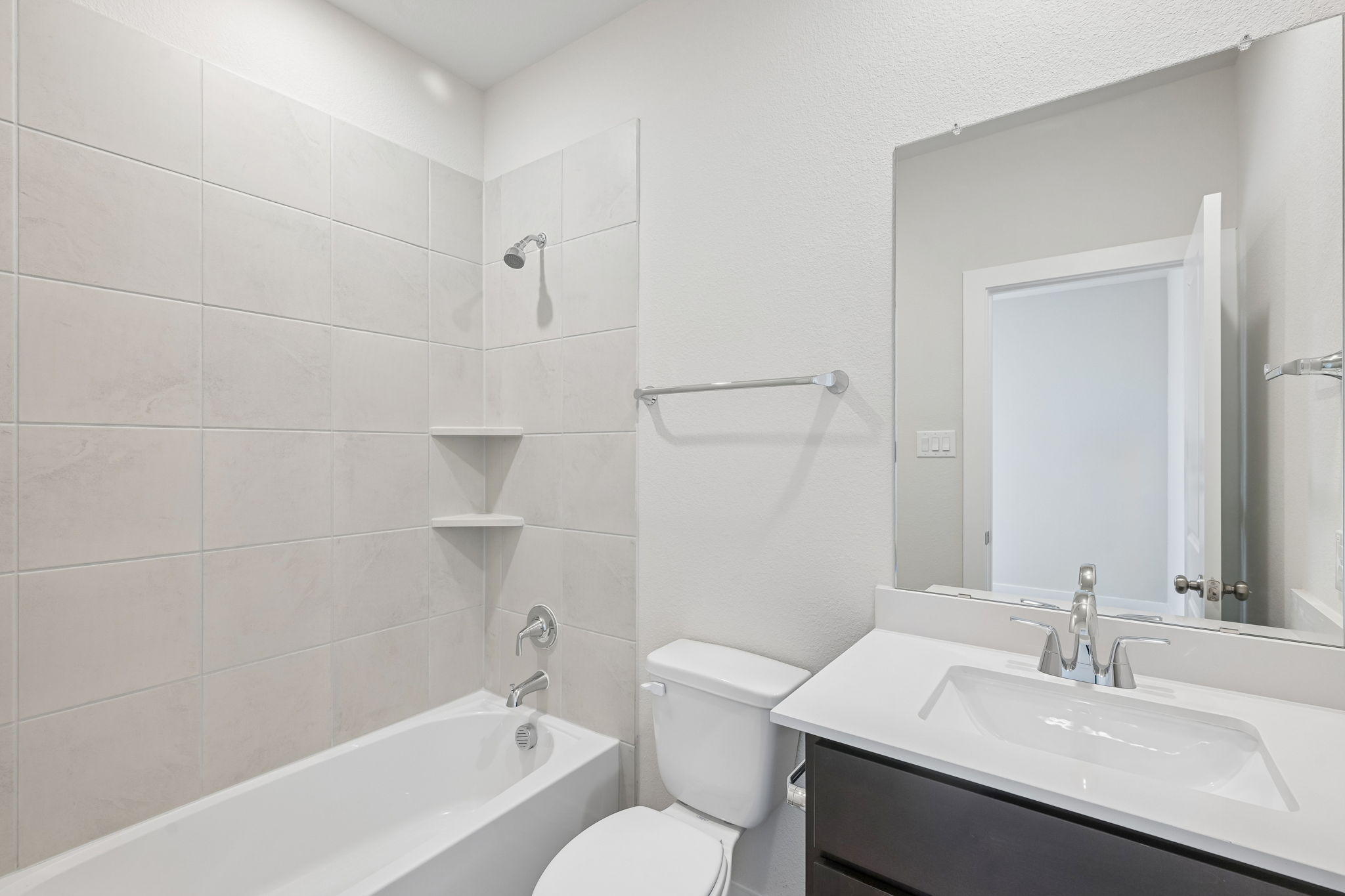 A bathroom with a tub sink and toilet.