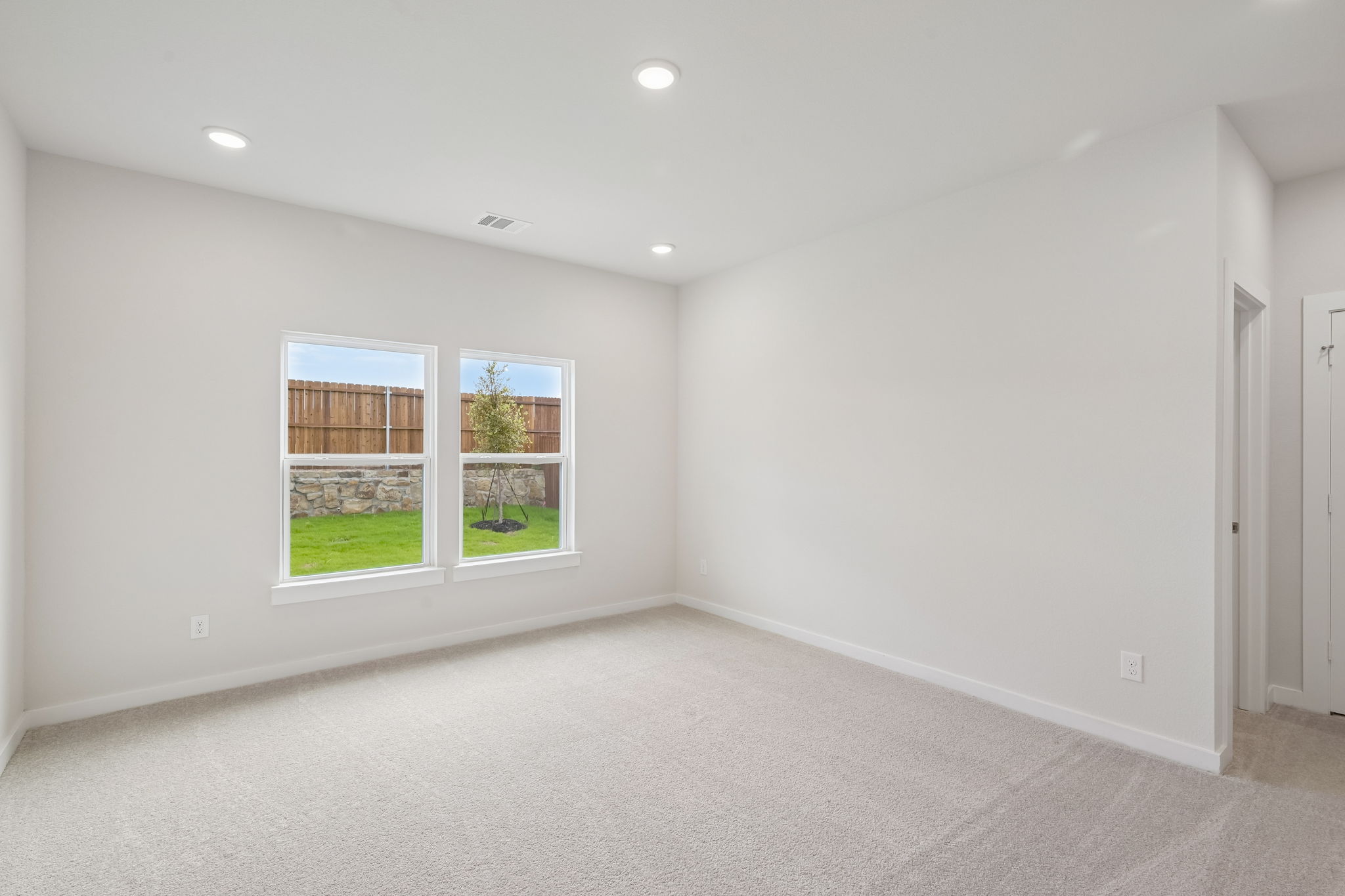A room with a window and a door.