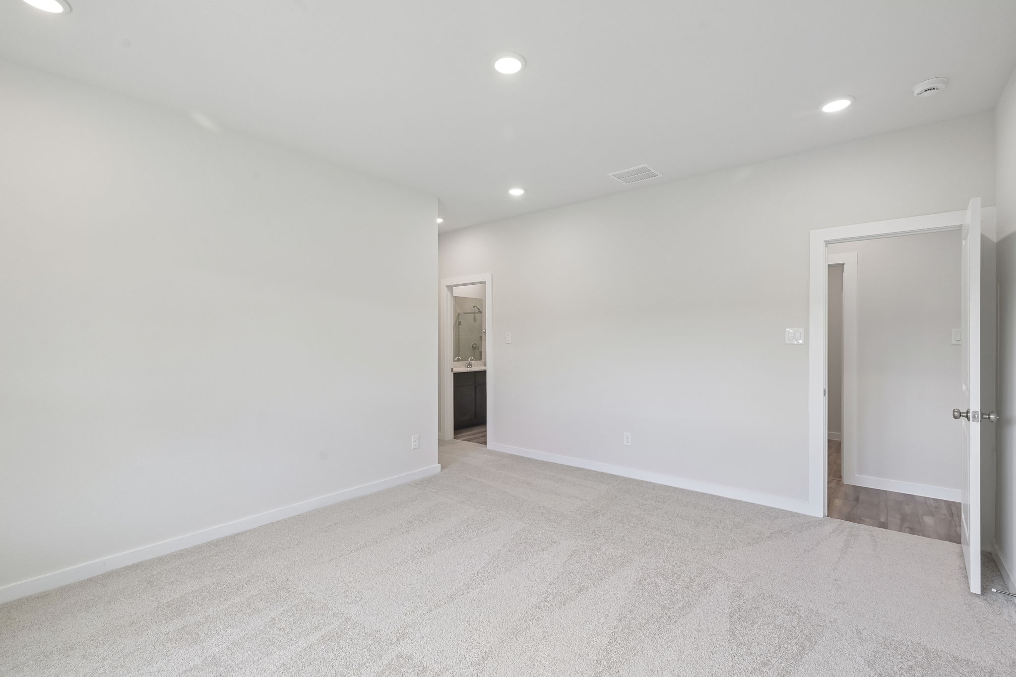 A hallway with white walls.