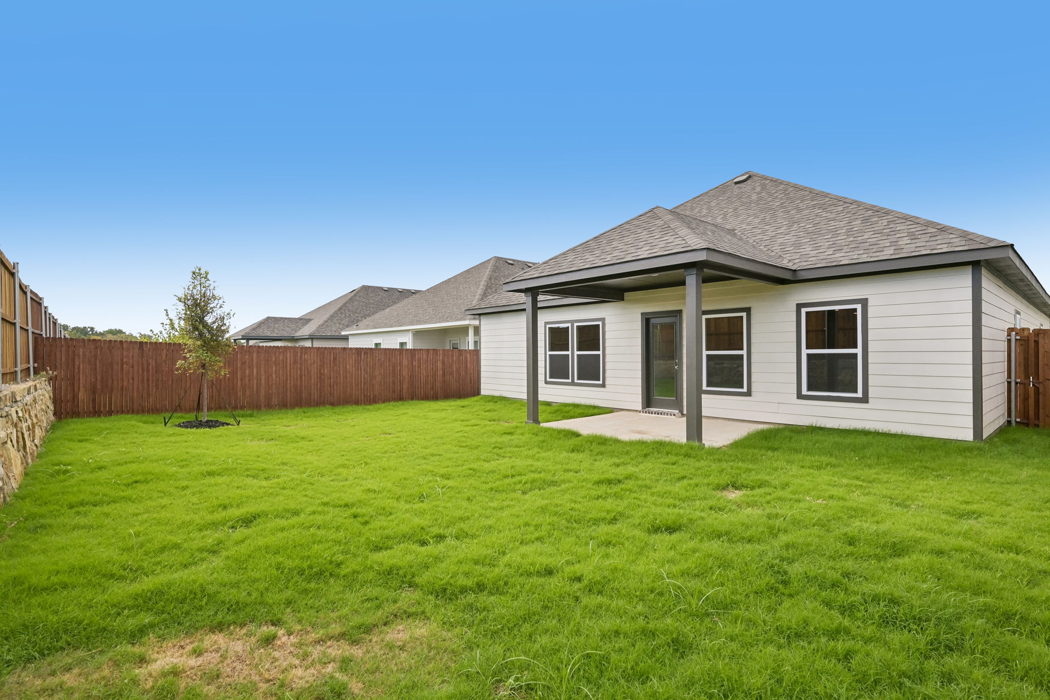 A house with a fence and grass.