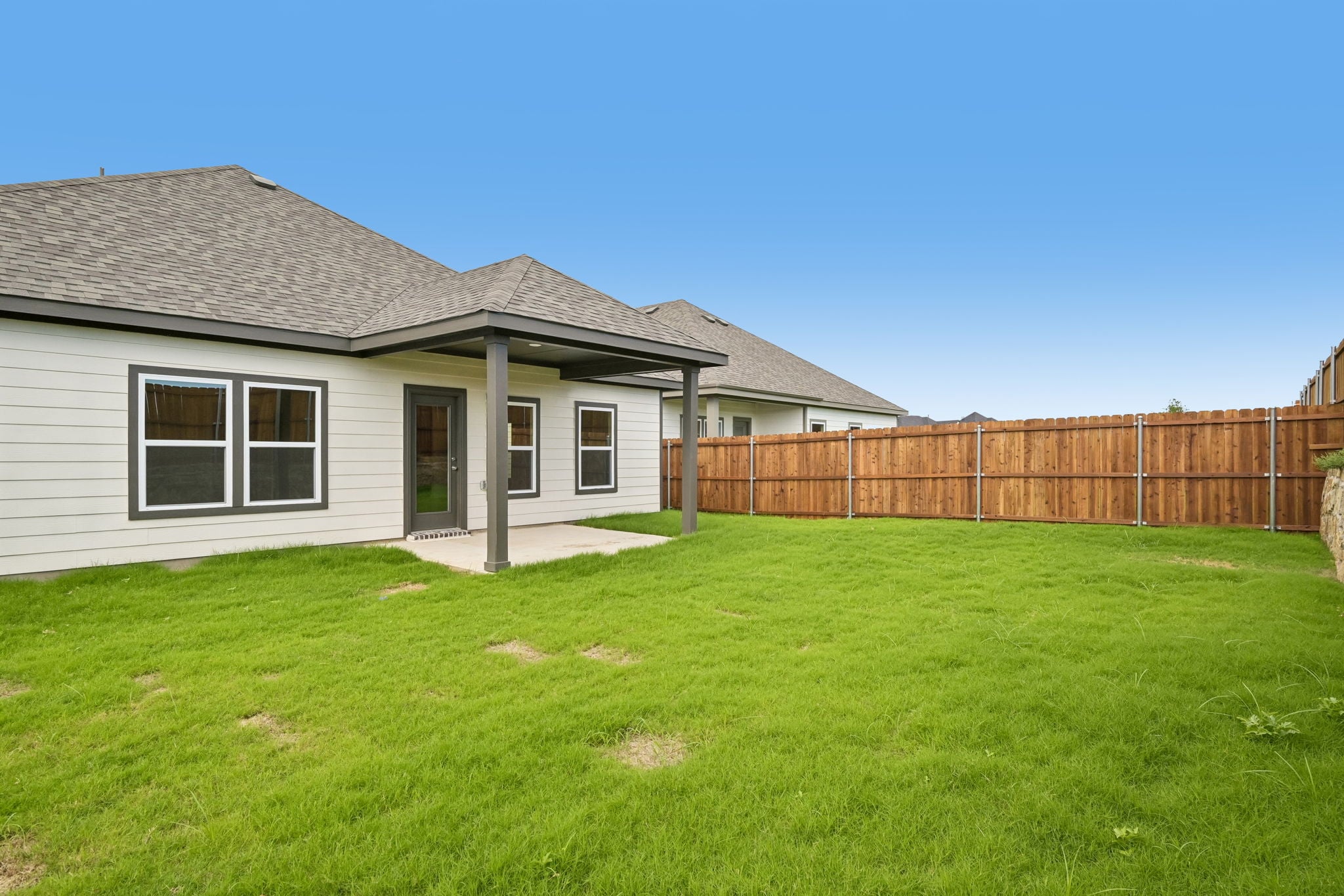 A house with a fence and grass.