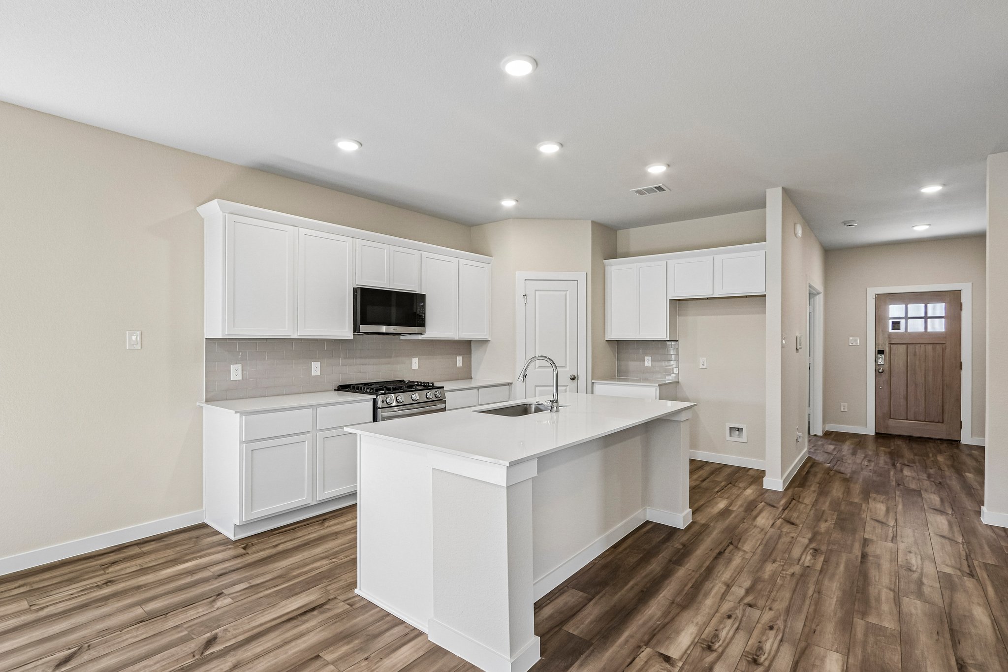 A kitchen with white cabinets.