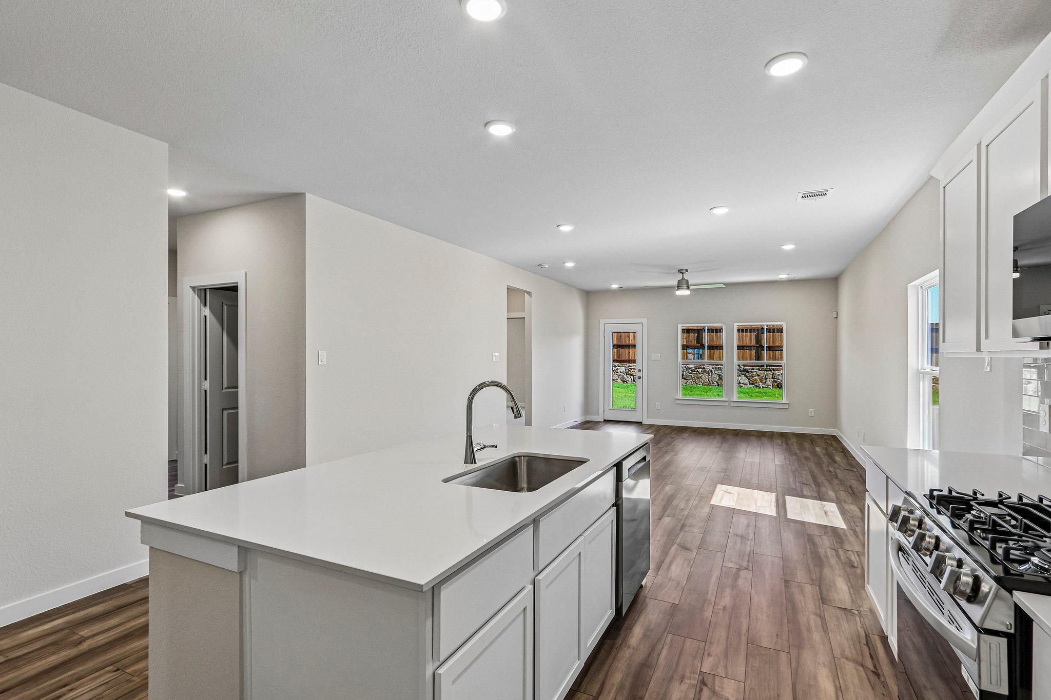 A kitchen with a wood floor.