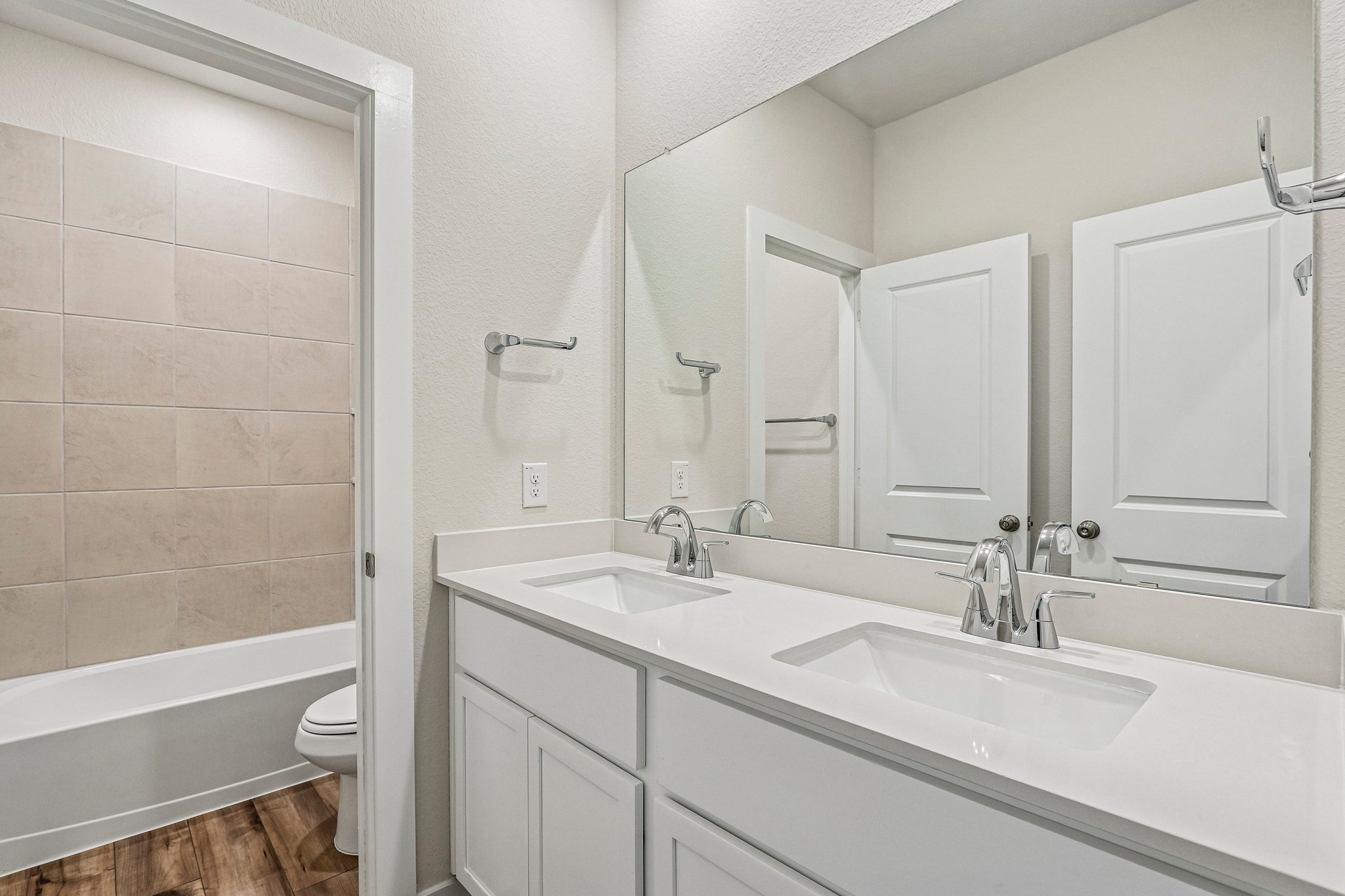 A bathroom with a sink and a toilet.