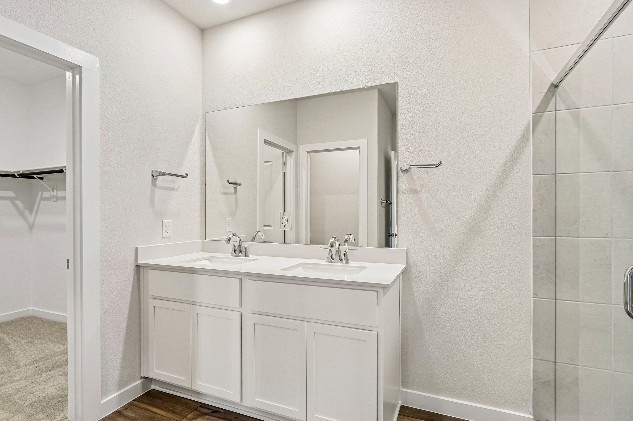 A bathroom with a shower and sink.