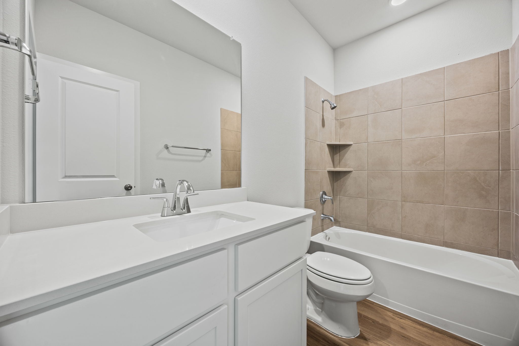 A bathroom with a tub sink and toilet.