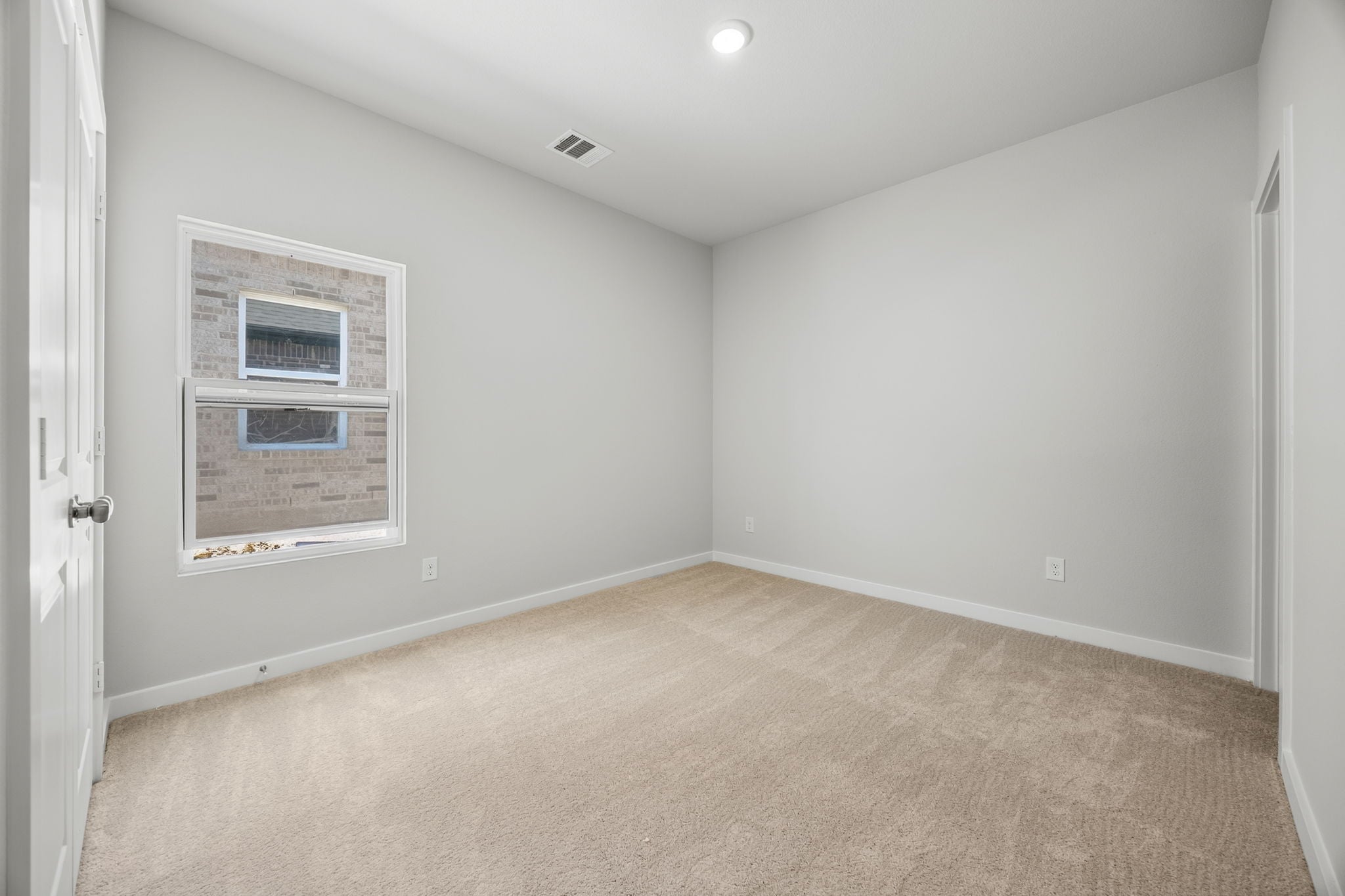 A room with a window and a door.