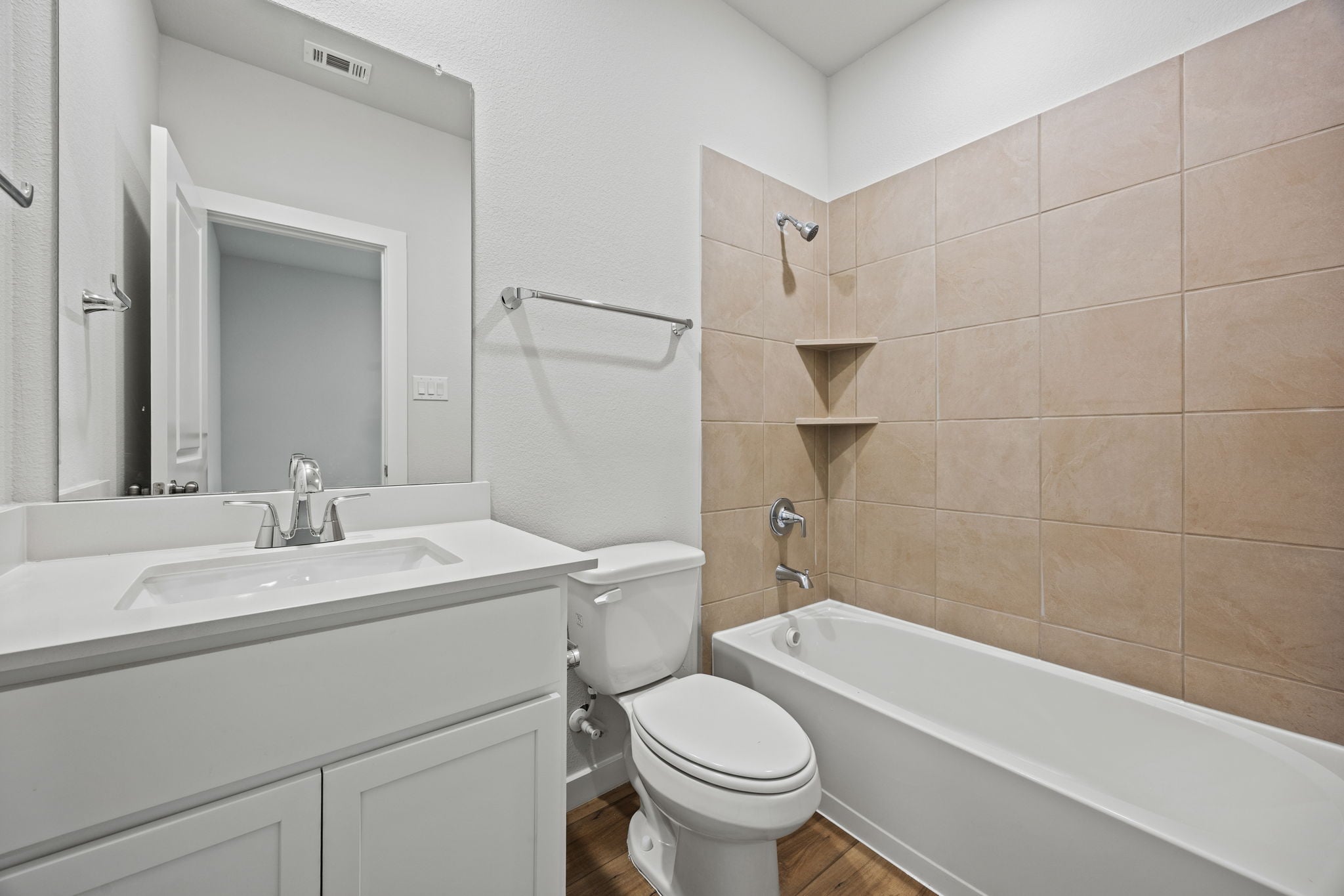 A bathroom with a tub toilet and sink.