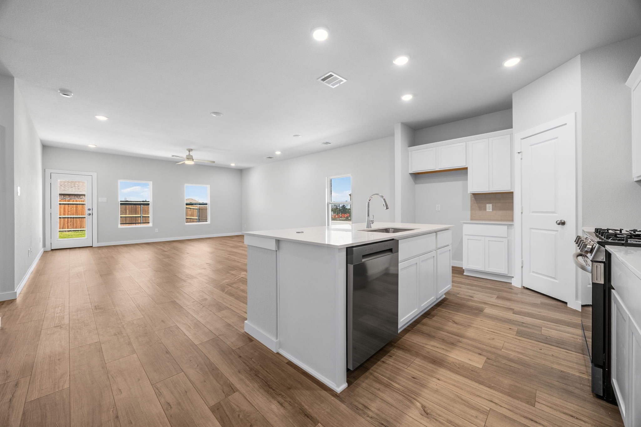 A kitchen with white cabinets.