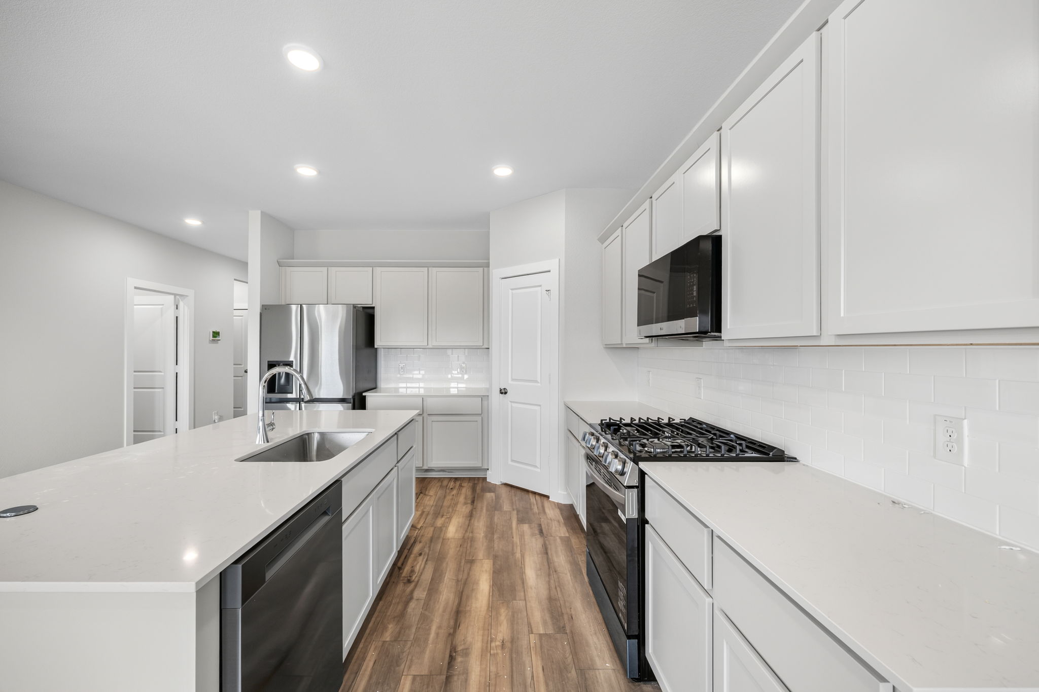 A kitchen with white cabinets.