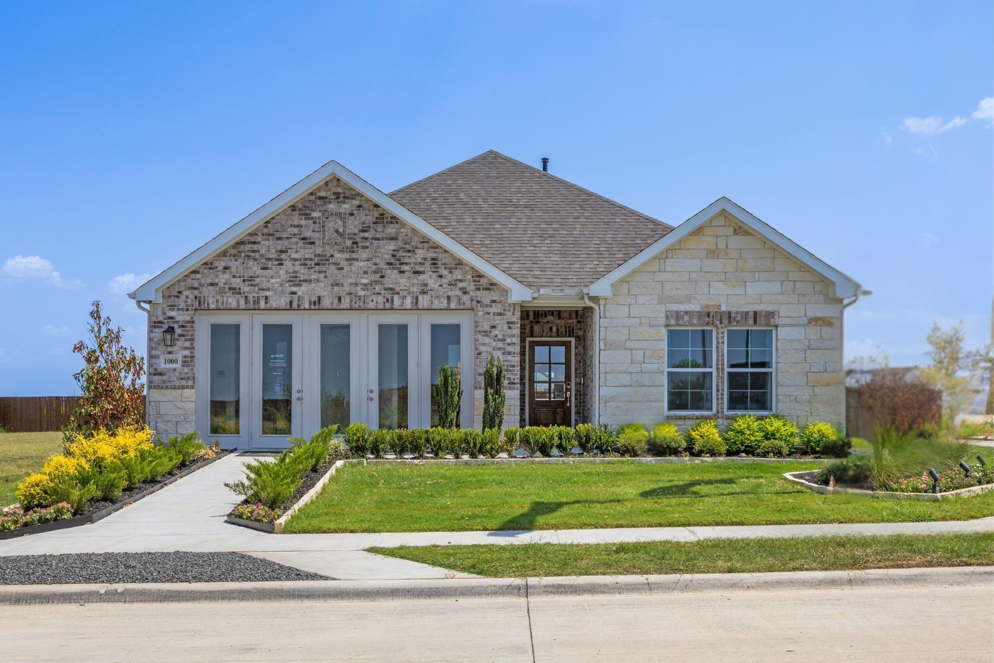 A house with a lawn and a driveway.