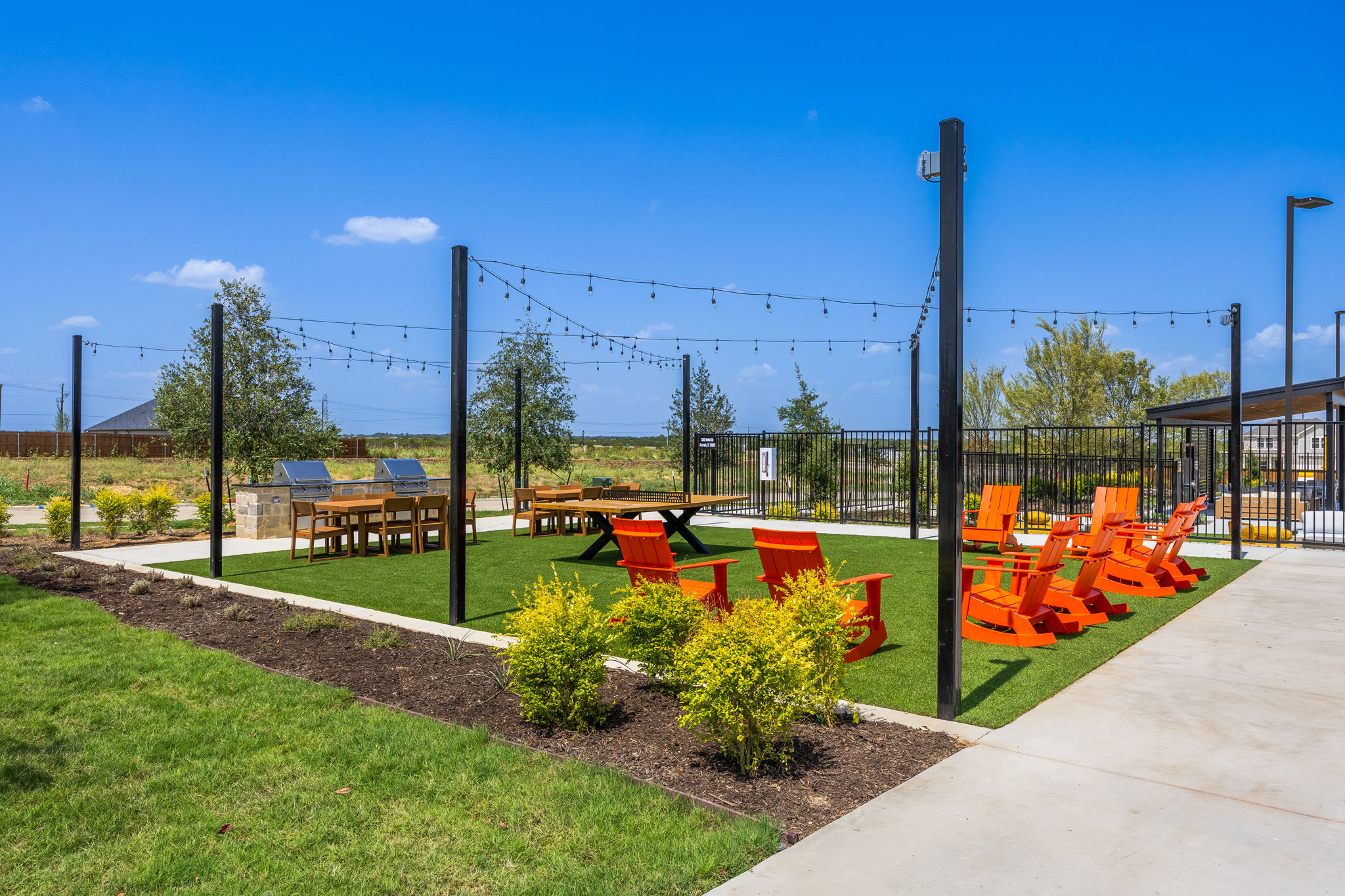 A playground with a fence and a path.