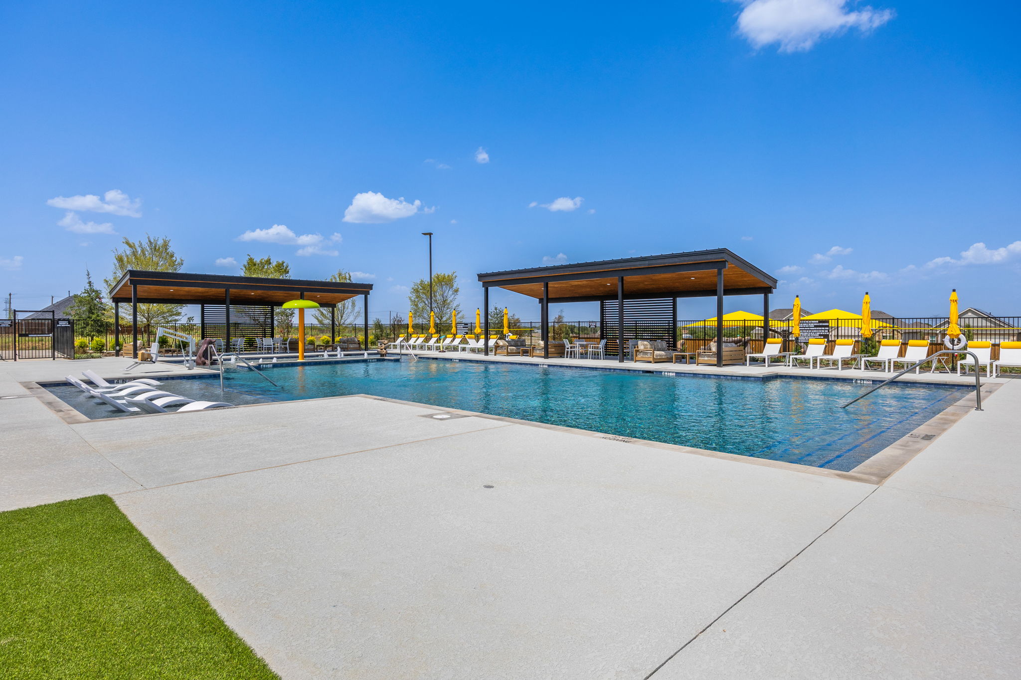 A swimming pool with a building in the background.