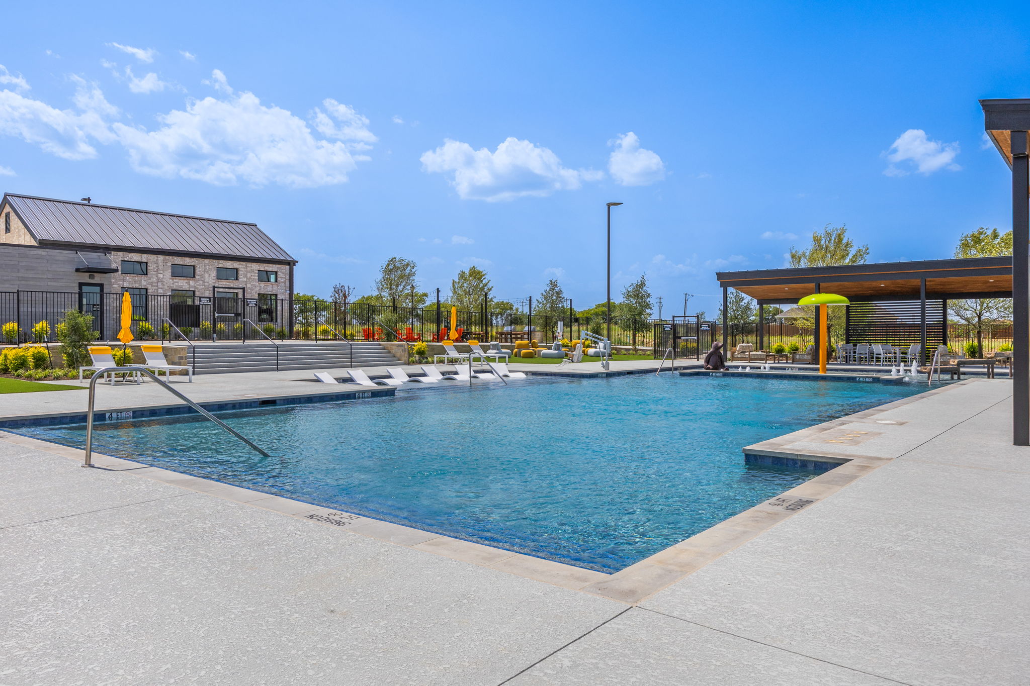 A swimming pool with a building in the background.