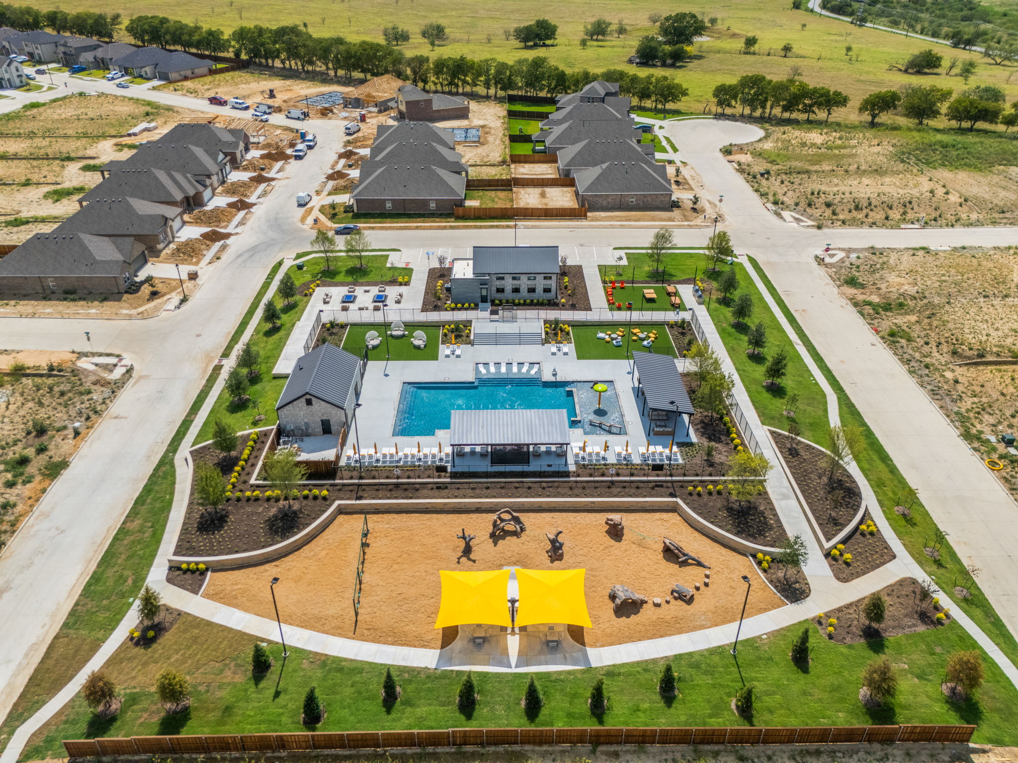 A large building with a pool in front of it.