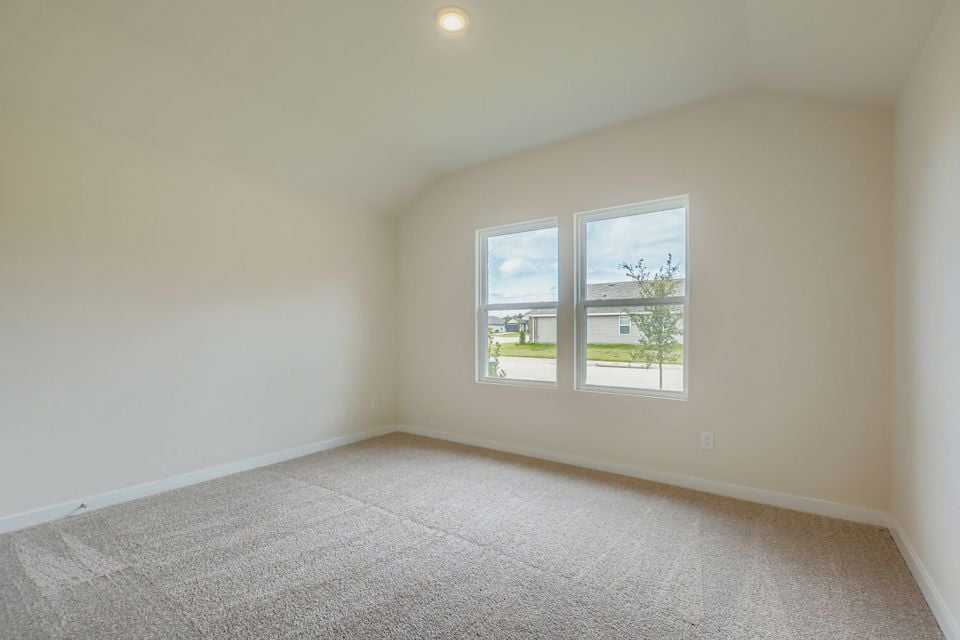 A room with a window and carpet.