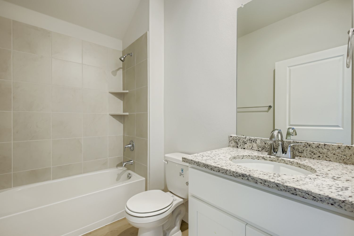 A bathroom with a tub sink and toilet.