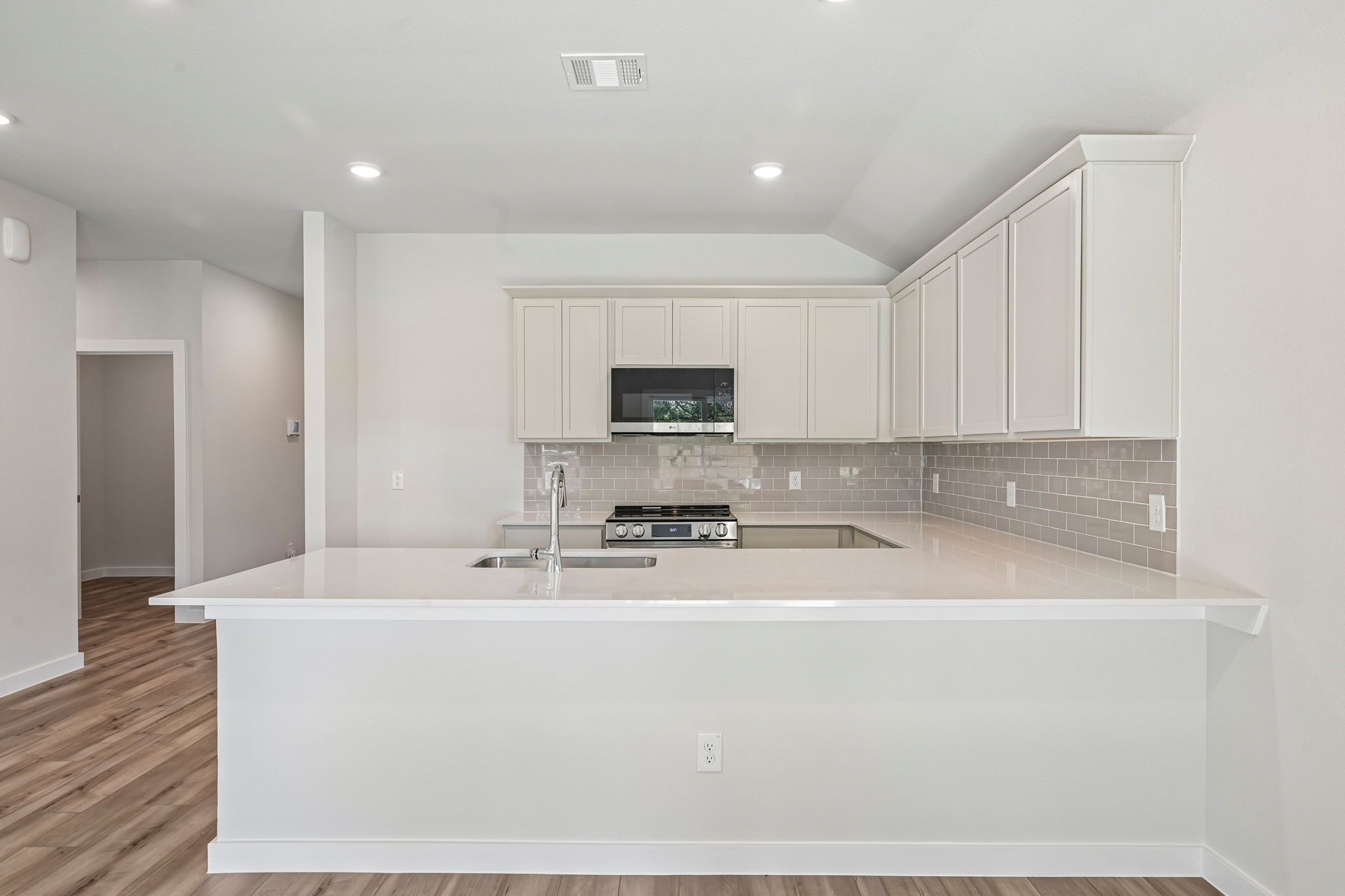 A kitchen with white cabinets.