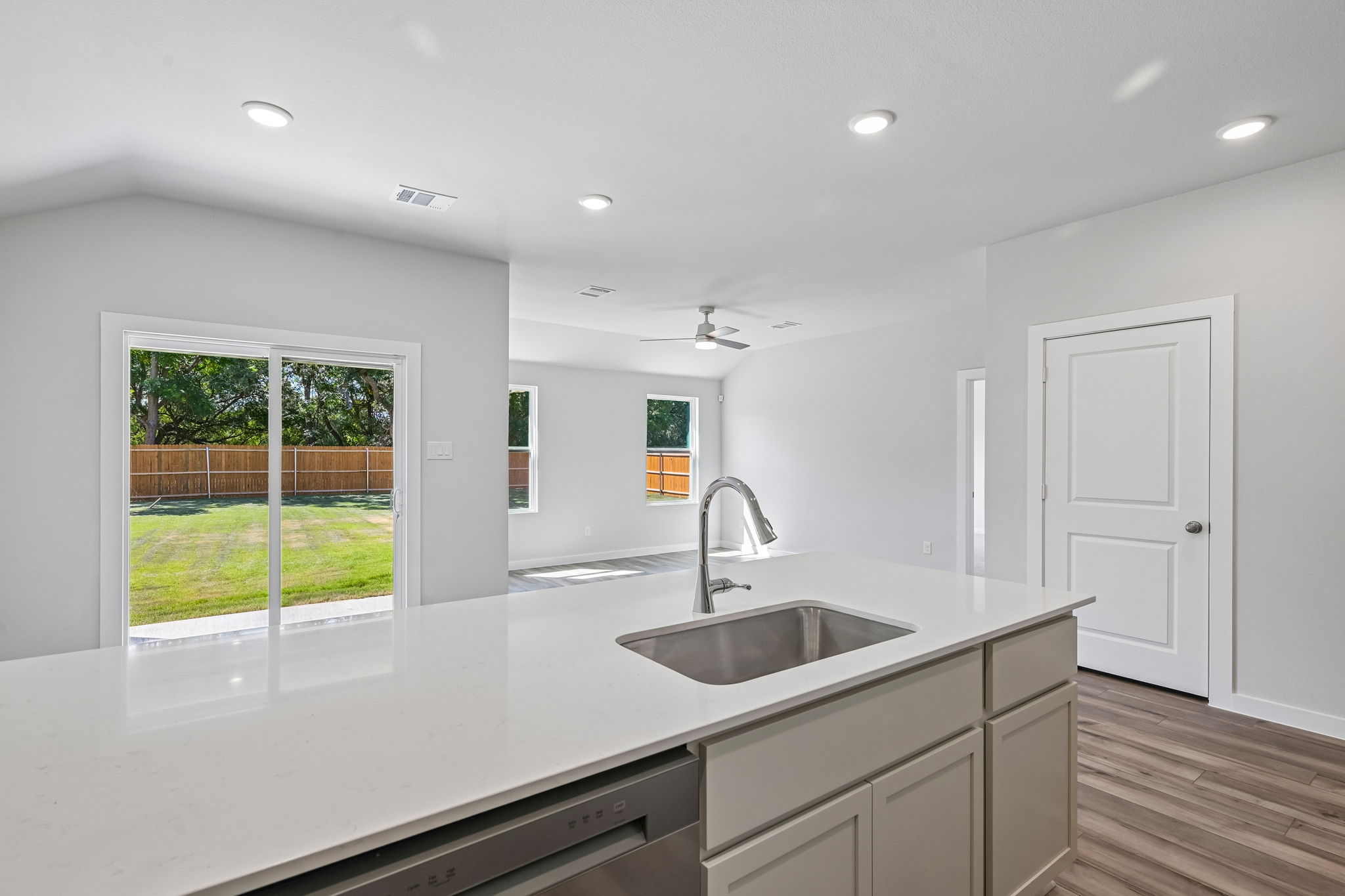 A kitchen with a large window.