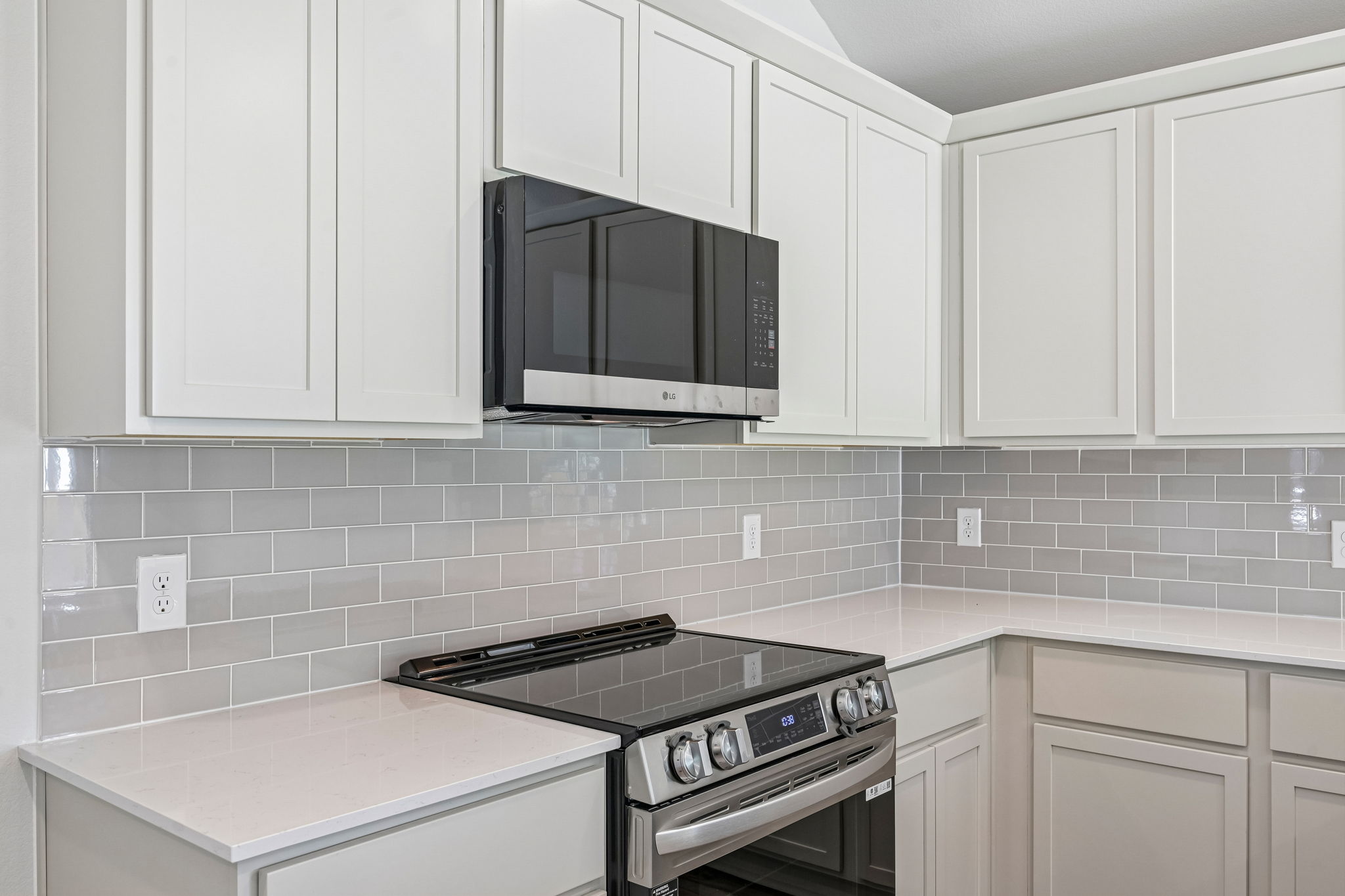 A kitchen with white cabinets.