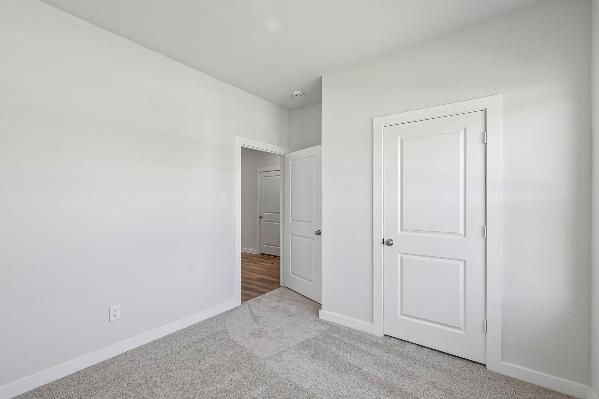 A hallway with white doors.