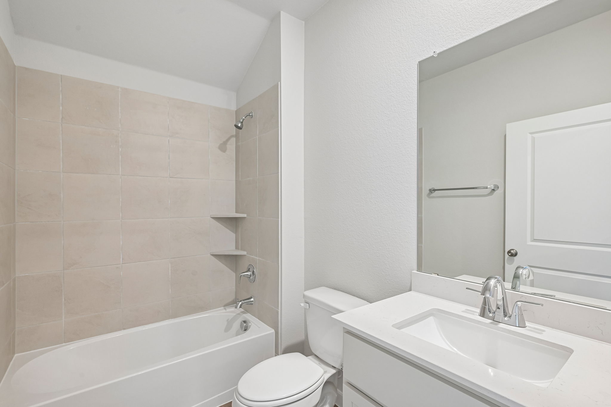 A bathroom with a tub sink and toilet.