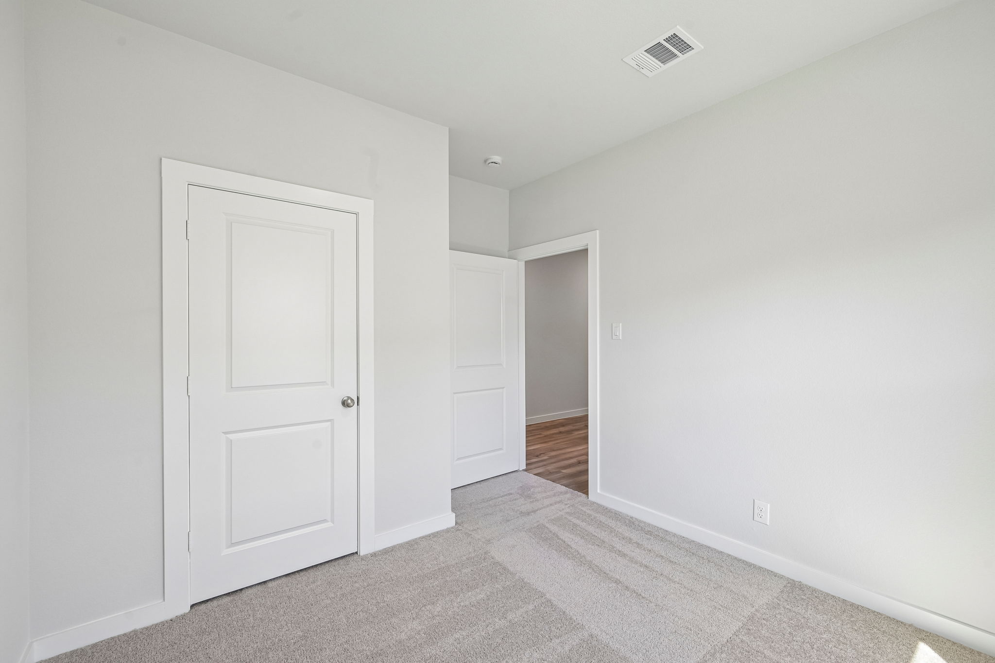 A hallway with white doors.