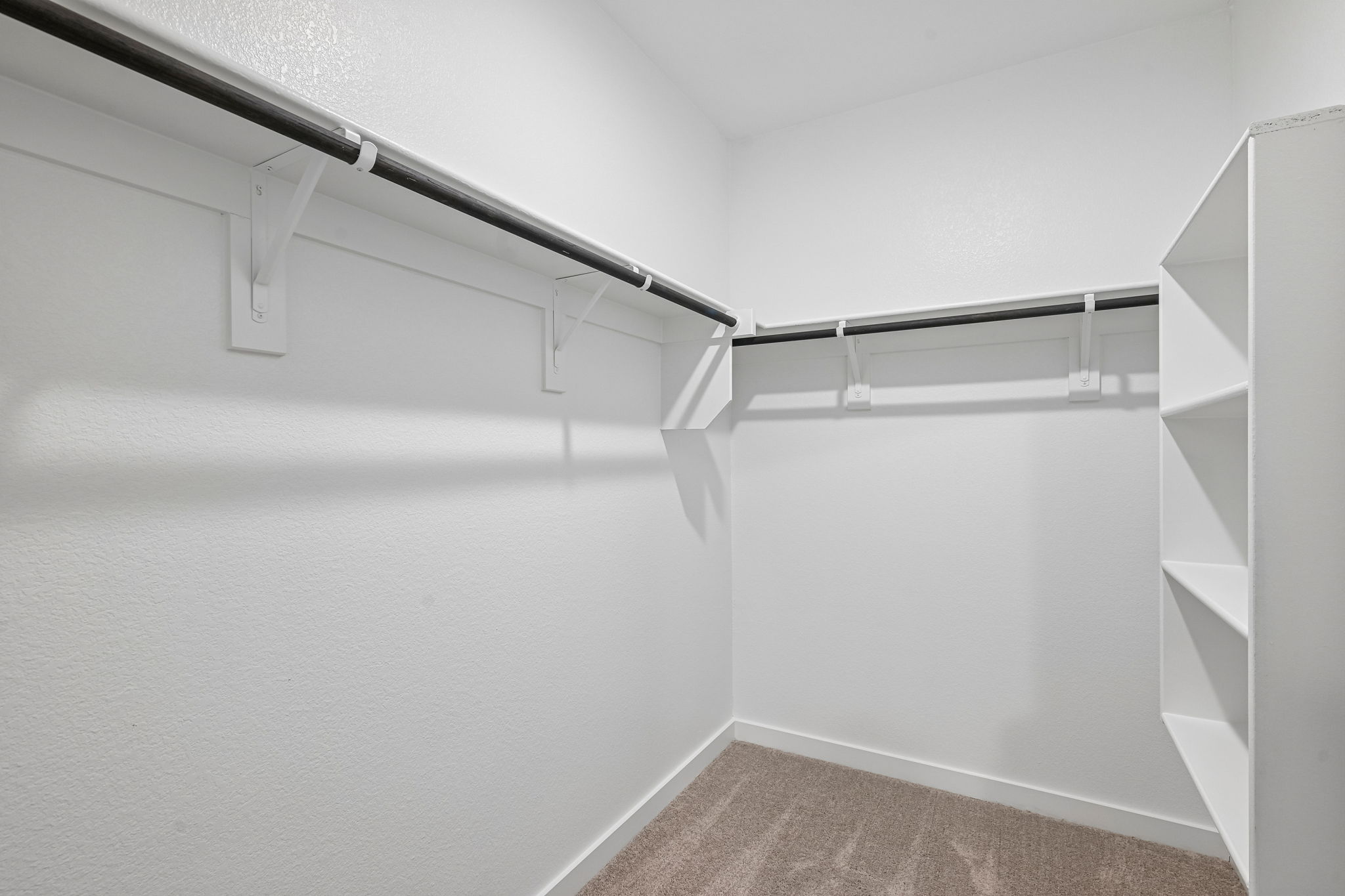 A white staircase with a white wall.
